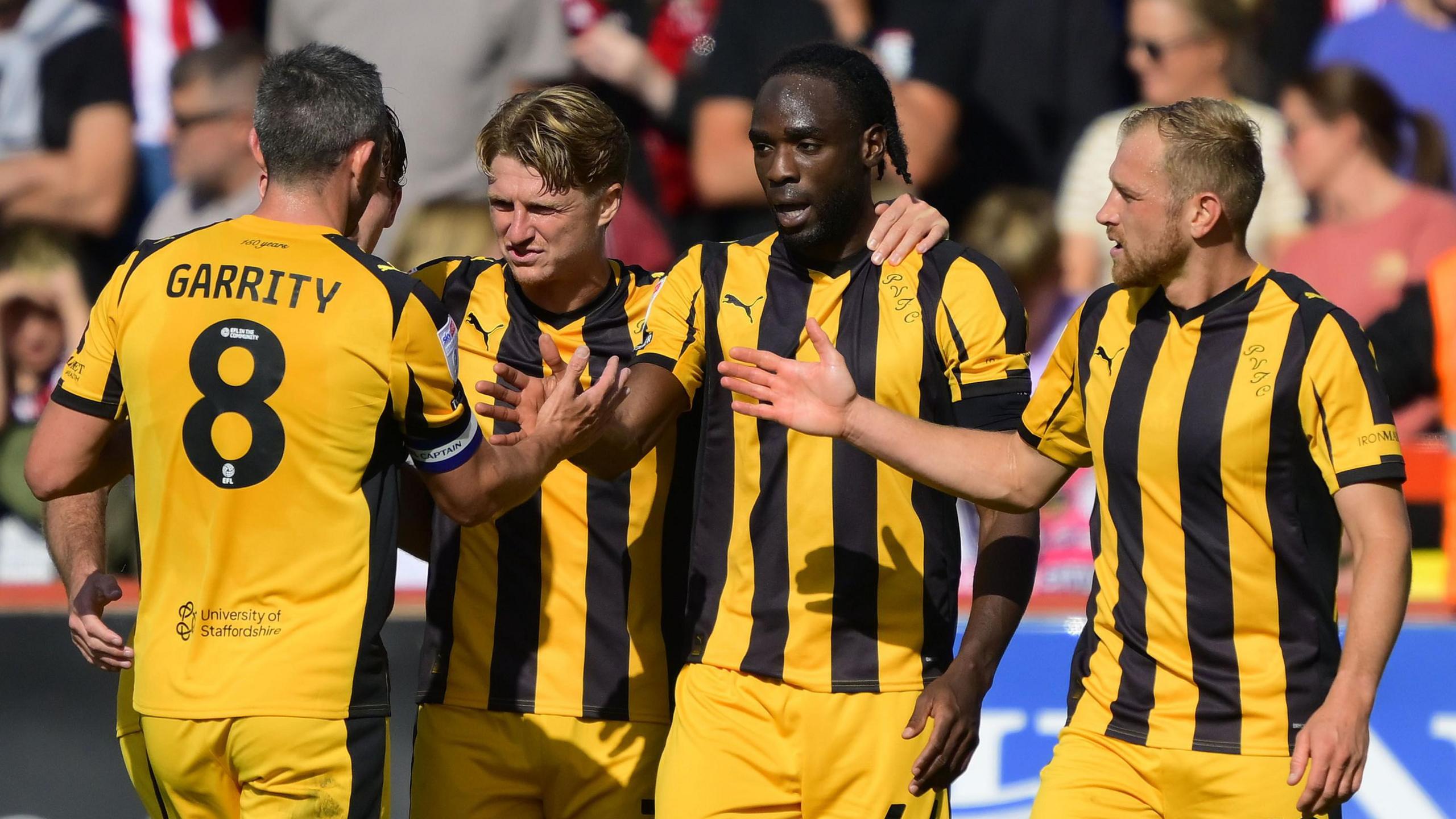 Devante Cole (middle) celebrates scoring with his Port Vale team-mates