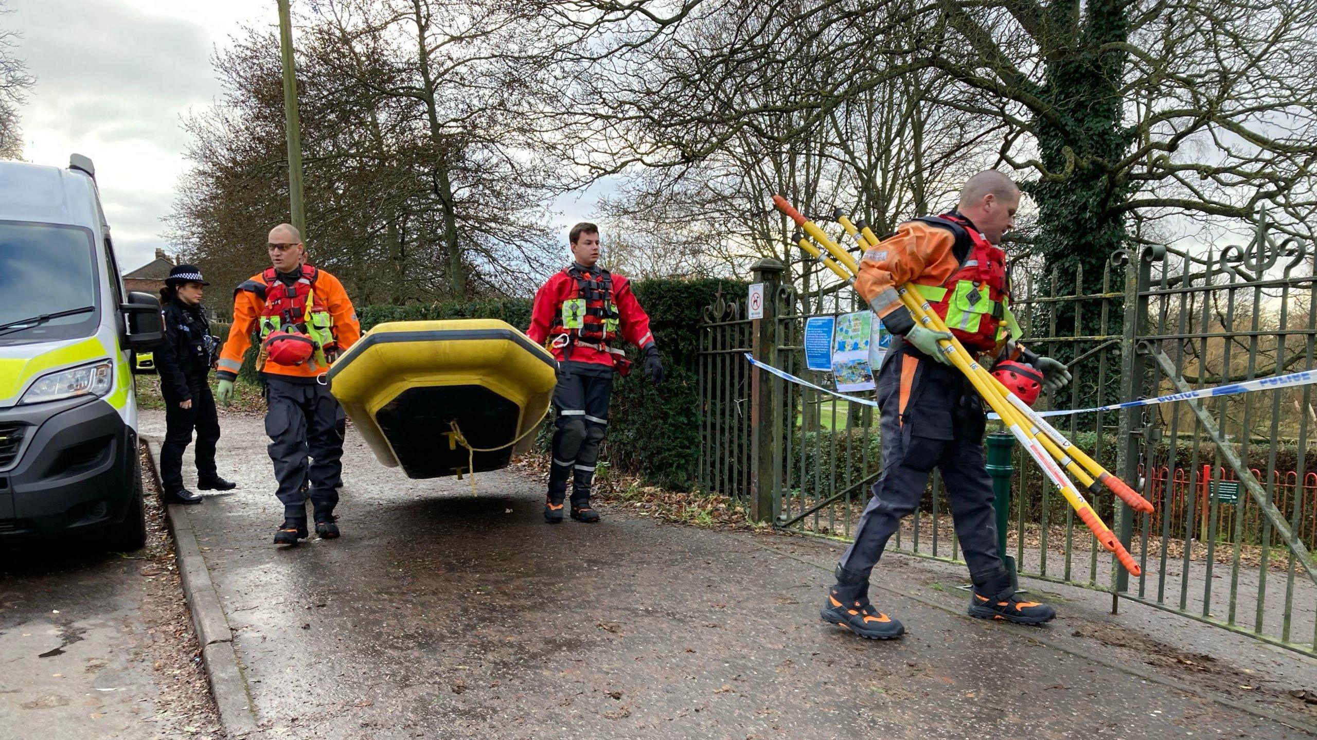 A search and rescue team carrying a boat