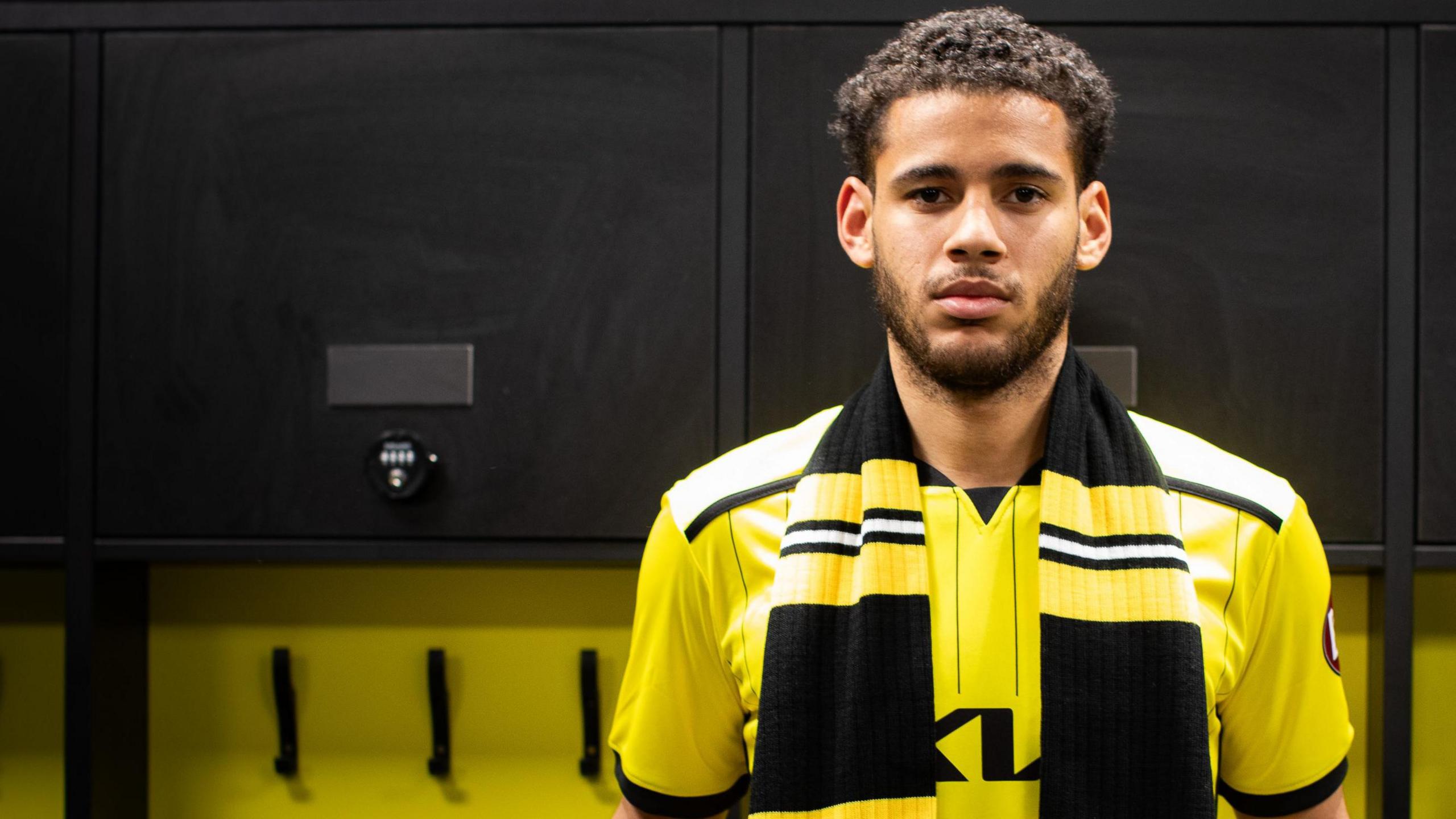 Kyran Lofthouse poses for pictures after signing for Burton