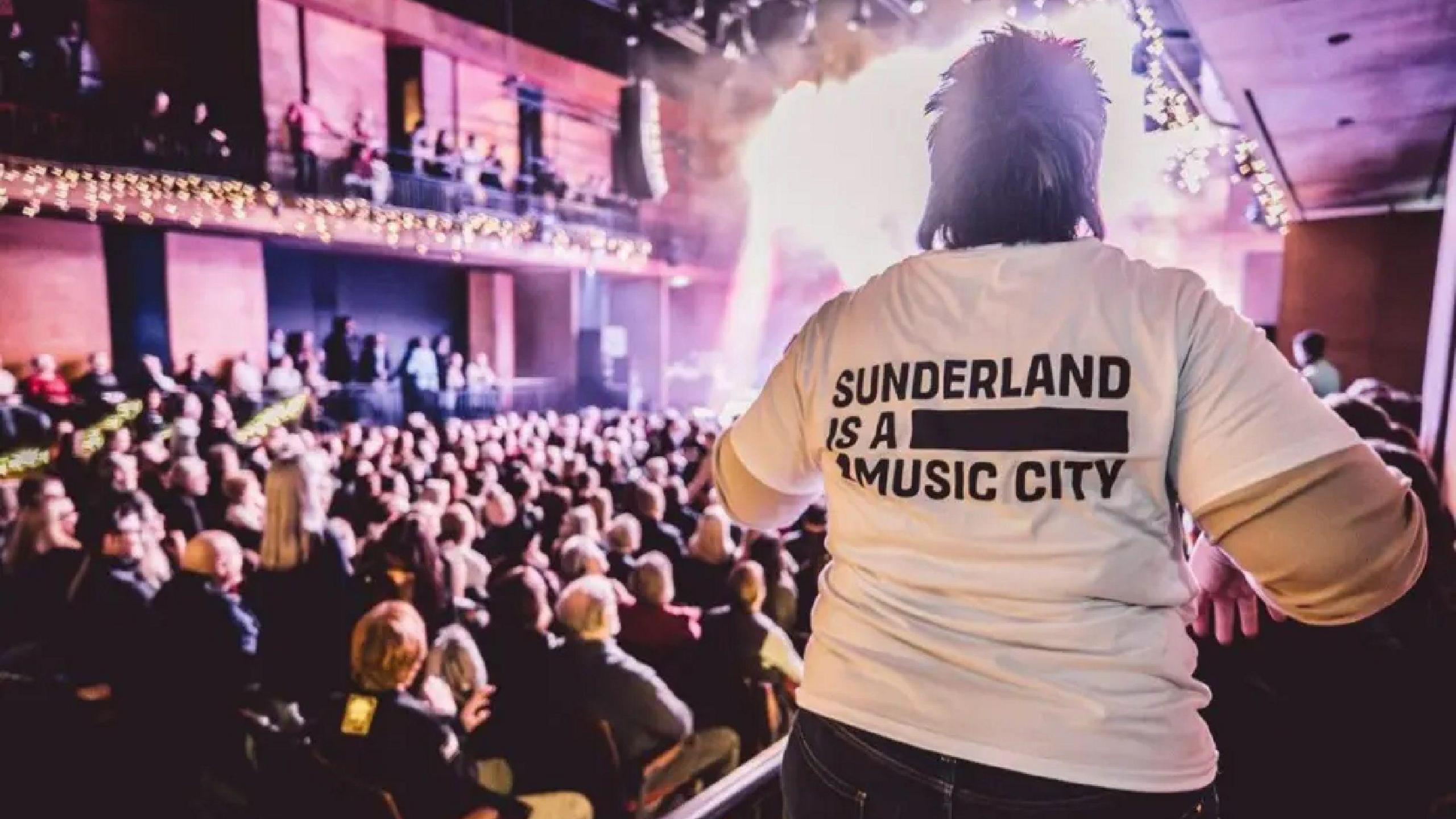 A music fan wearing a Sunderland Music City white T-shirt enjoys a sold out show at The Fire Station in Sunderland.