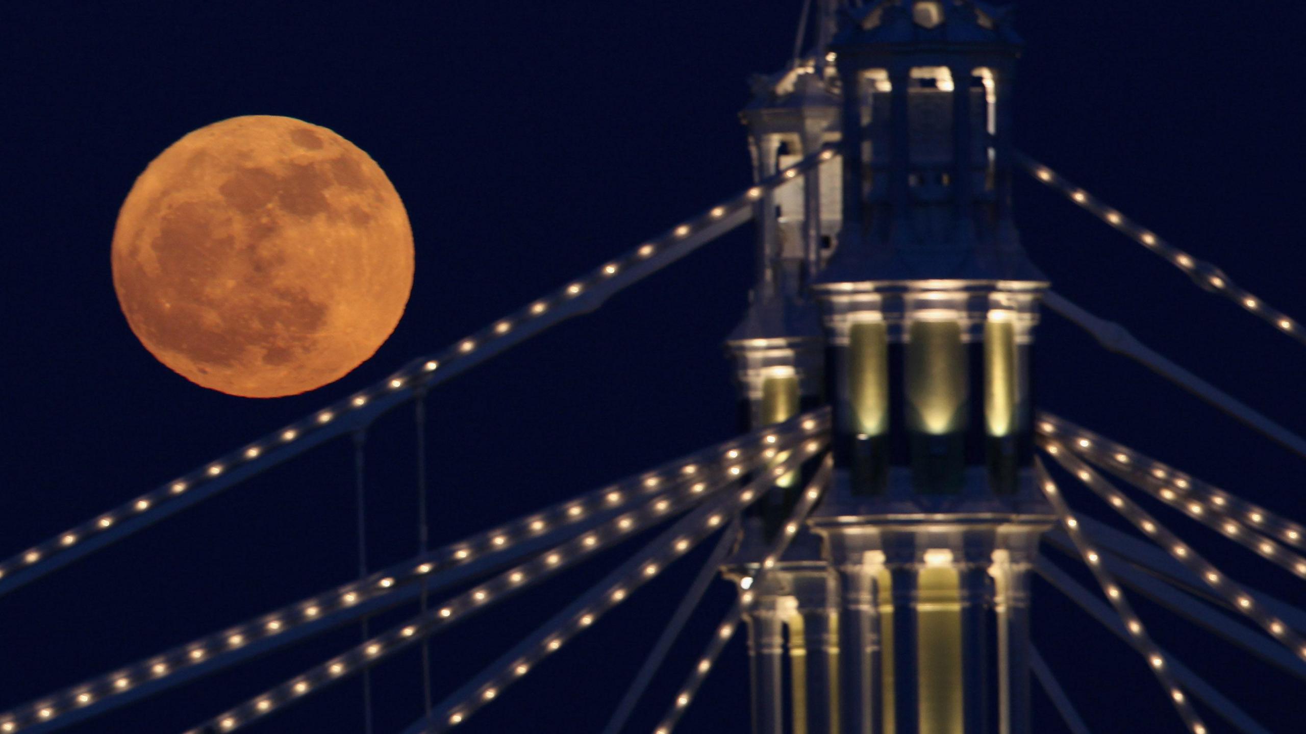 The Full moon rises over Albert Bridge on February 7, 2012 in London, England. Albert Bridge is said to be one of the most romantic bridges in London, and will be the start point for the flotilla of boats that will make their way along the Thames as part of the Queen's Diamond Jubilee celebration.