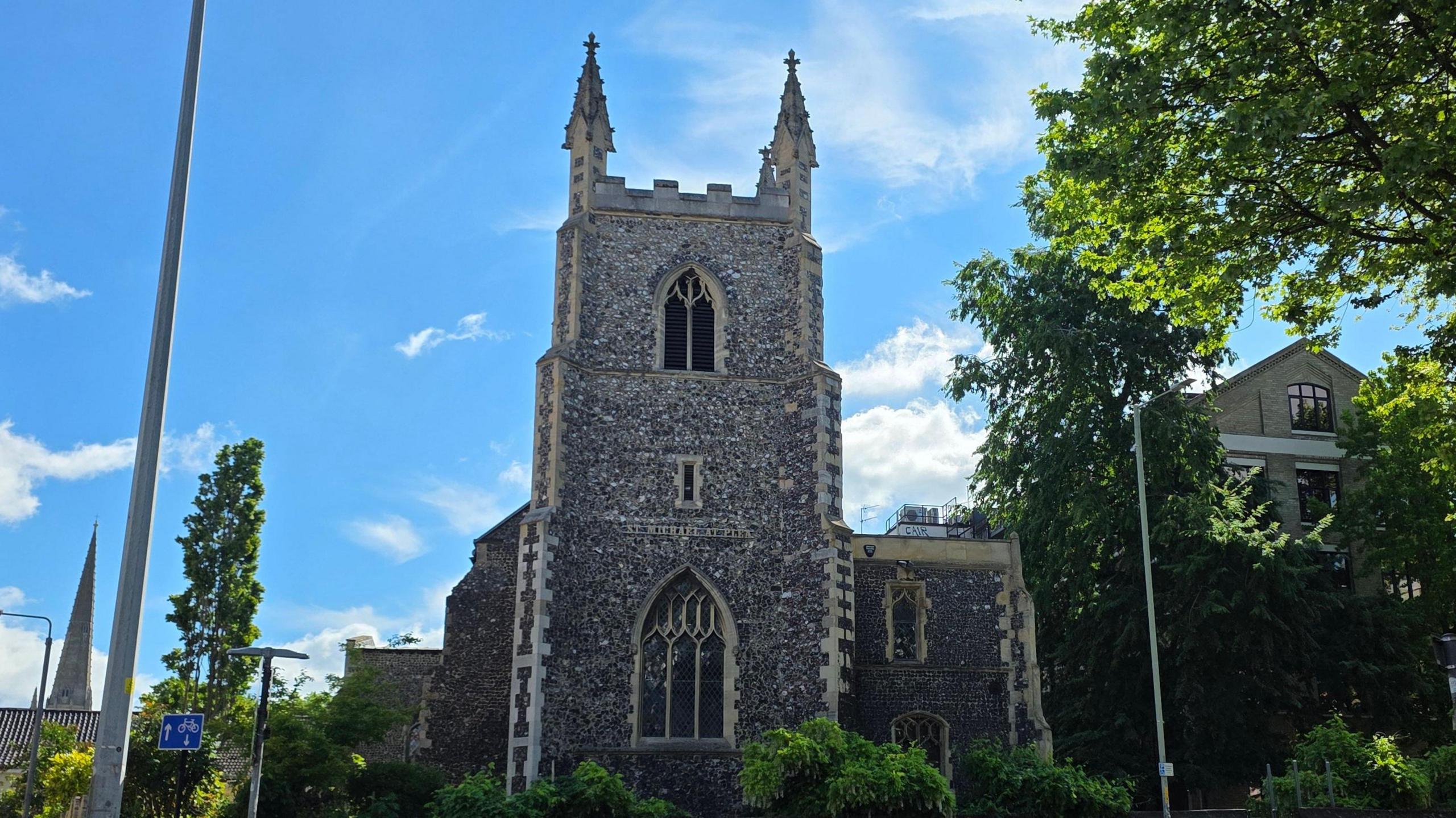We can see the church on a sunny day, with two of the pinnacles on top of the tower visible.