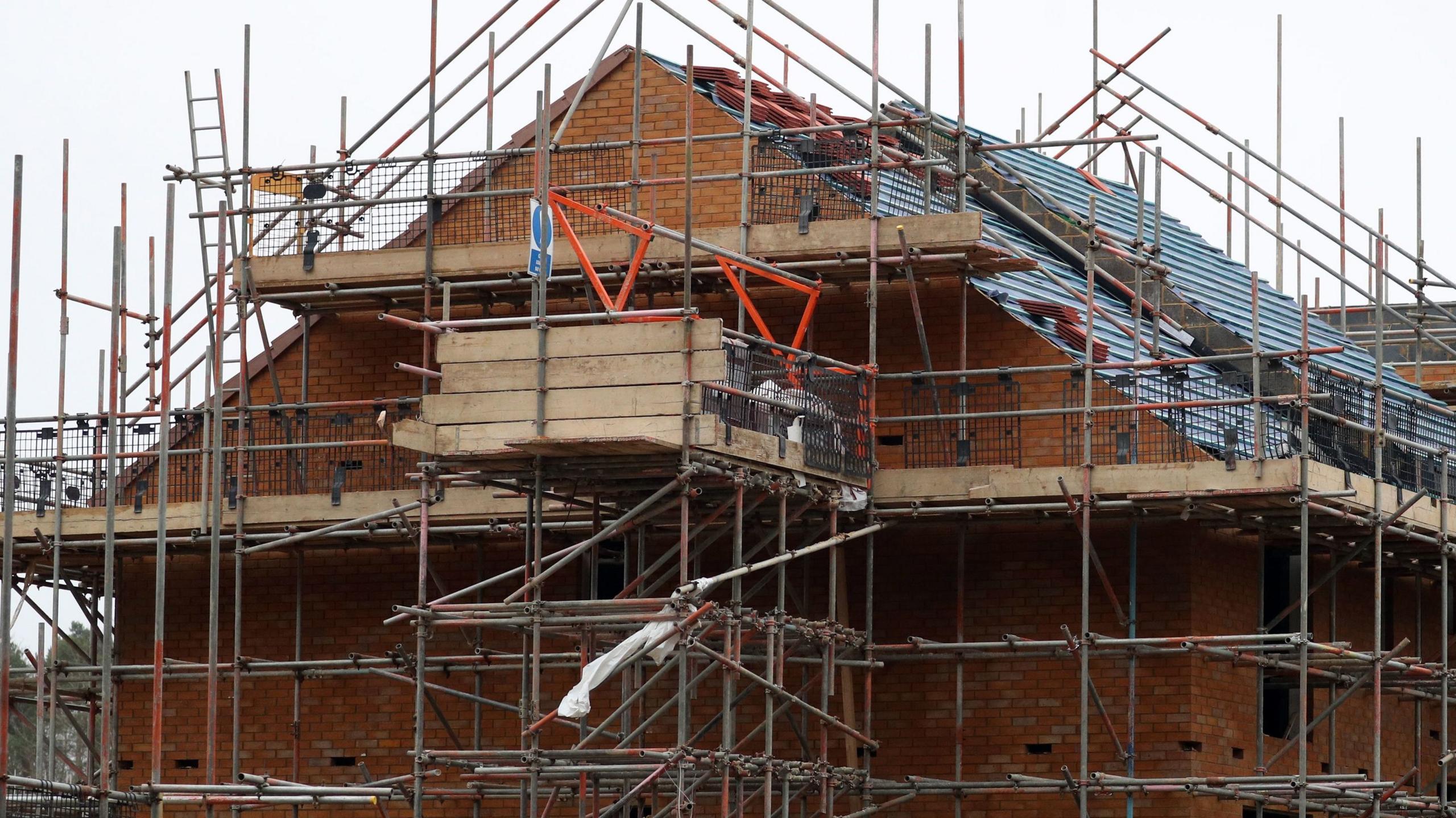 A new house being built surrounded by scaffolding