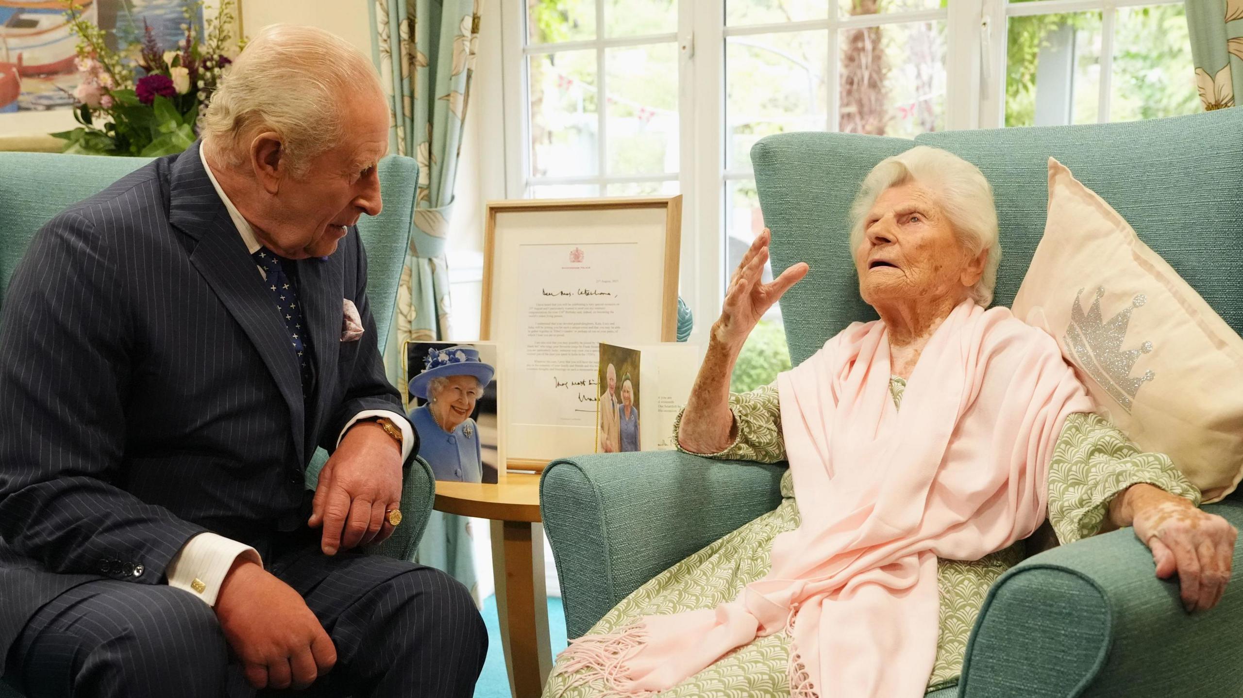 King Charles sitting opposite Ethel Caterham, who is the world's oldest living person at 117.
