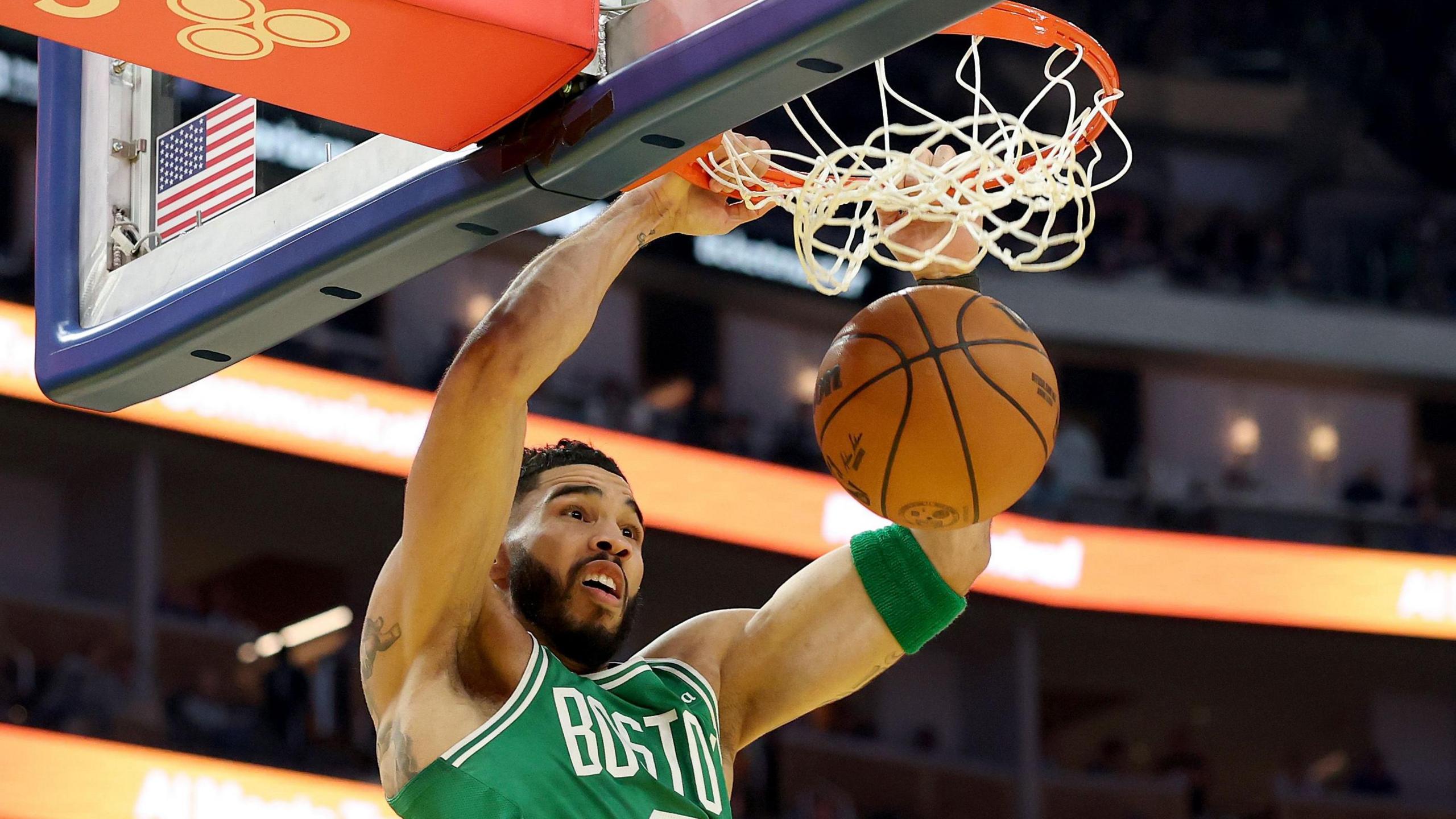 Jayson Tatum scores a basket for the Celtics