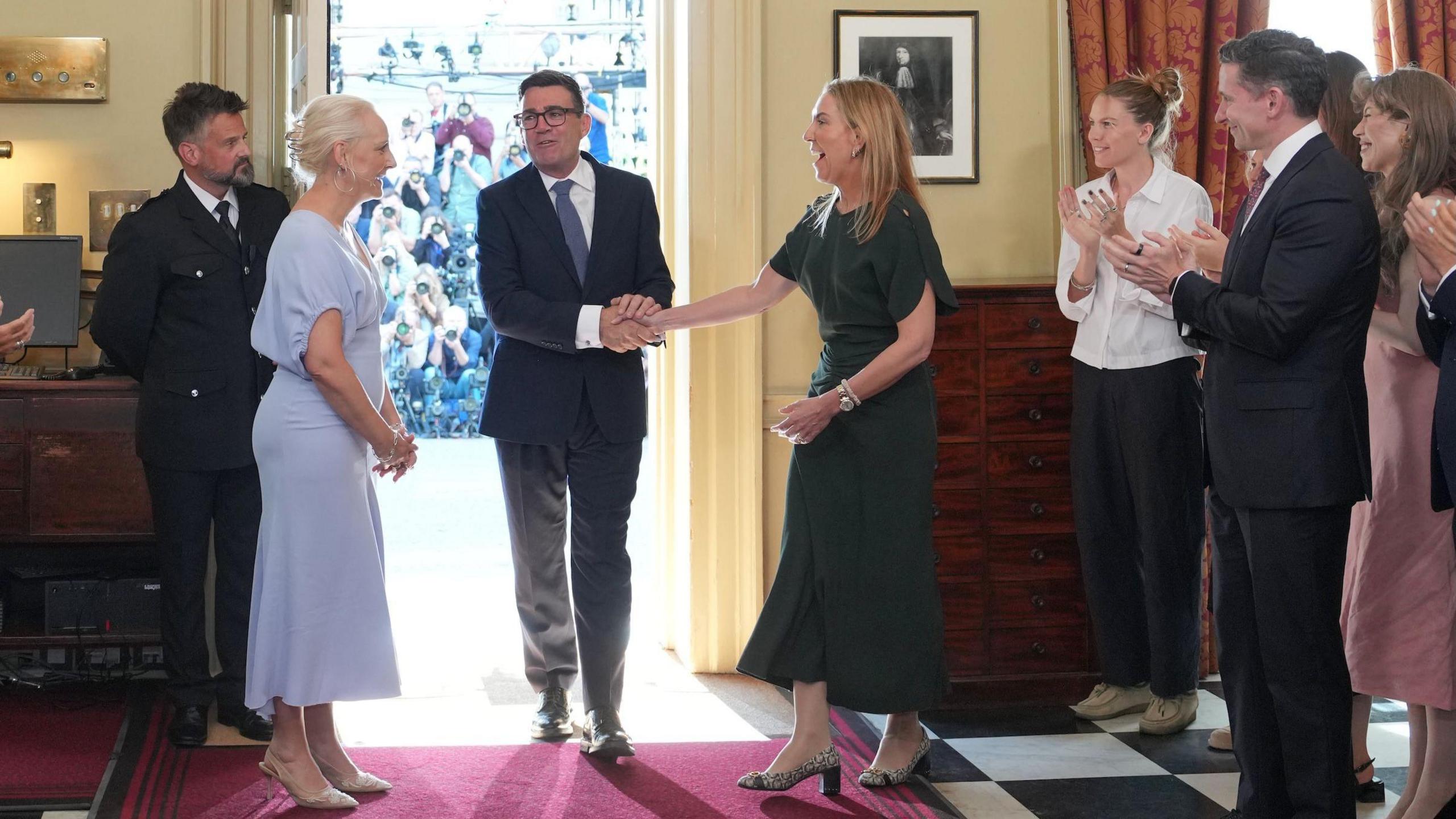 New Prime Minister Andy Burnham shakes hands with Dame Antonia Romeo as he walks into 10 Downing Street, London, for the first time as prime minister.