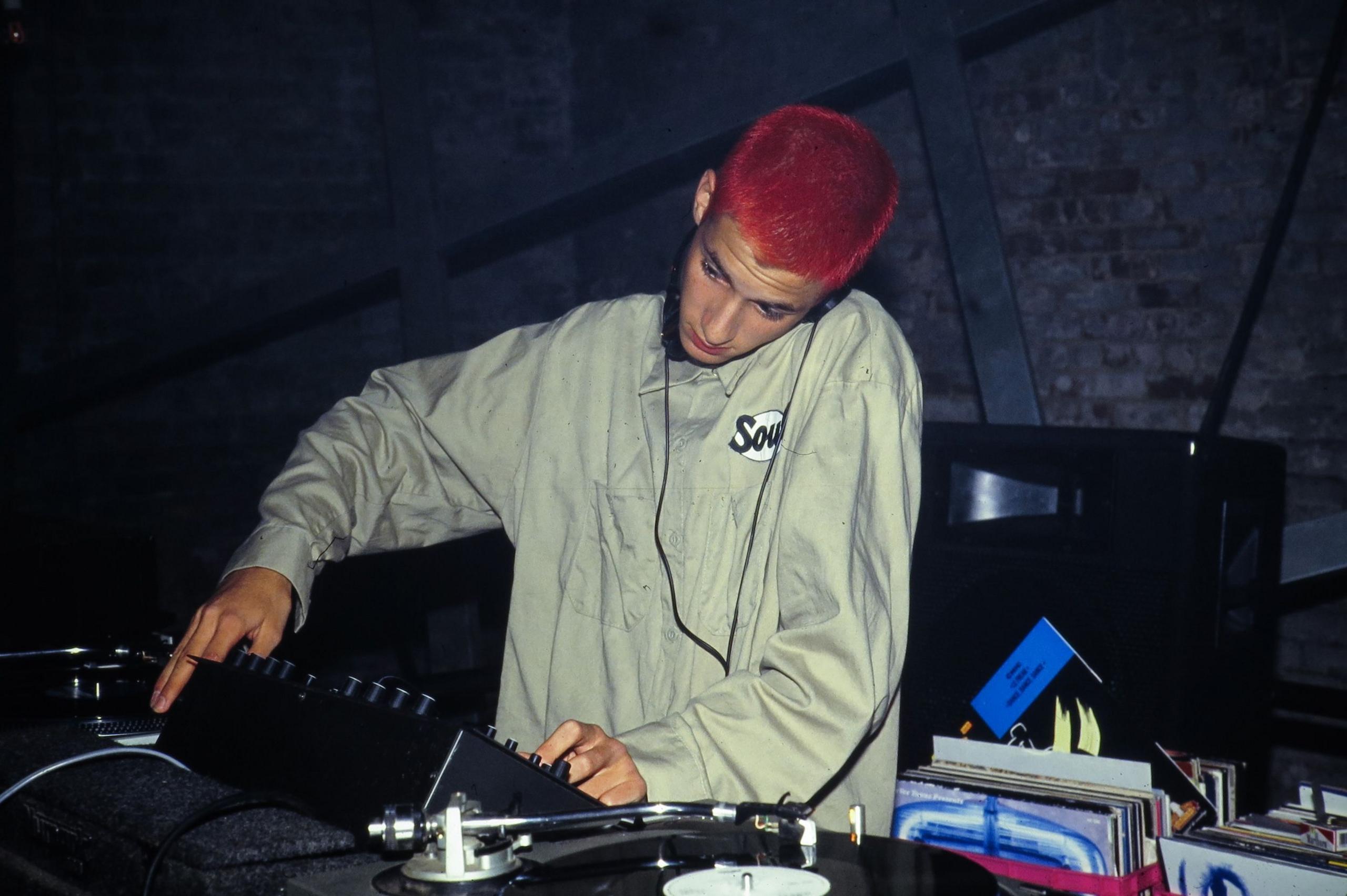 Mark Ronson, with his hair dyed red, DJs at an unidentified club in 1993