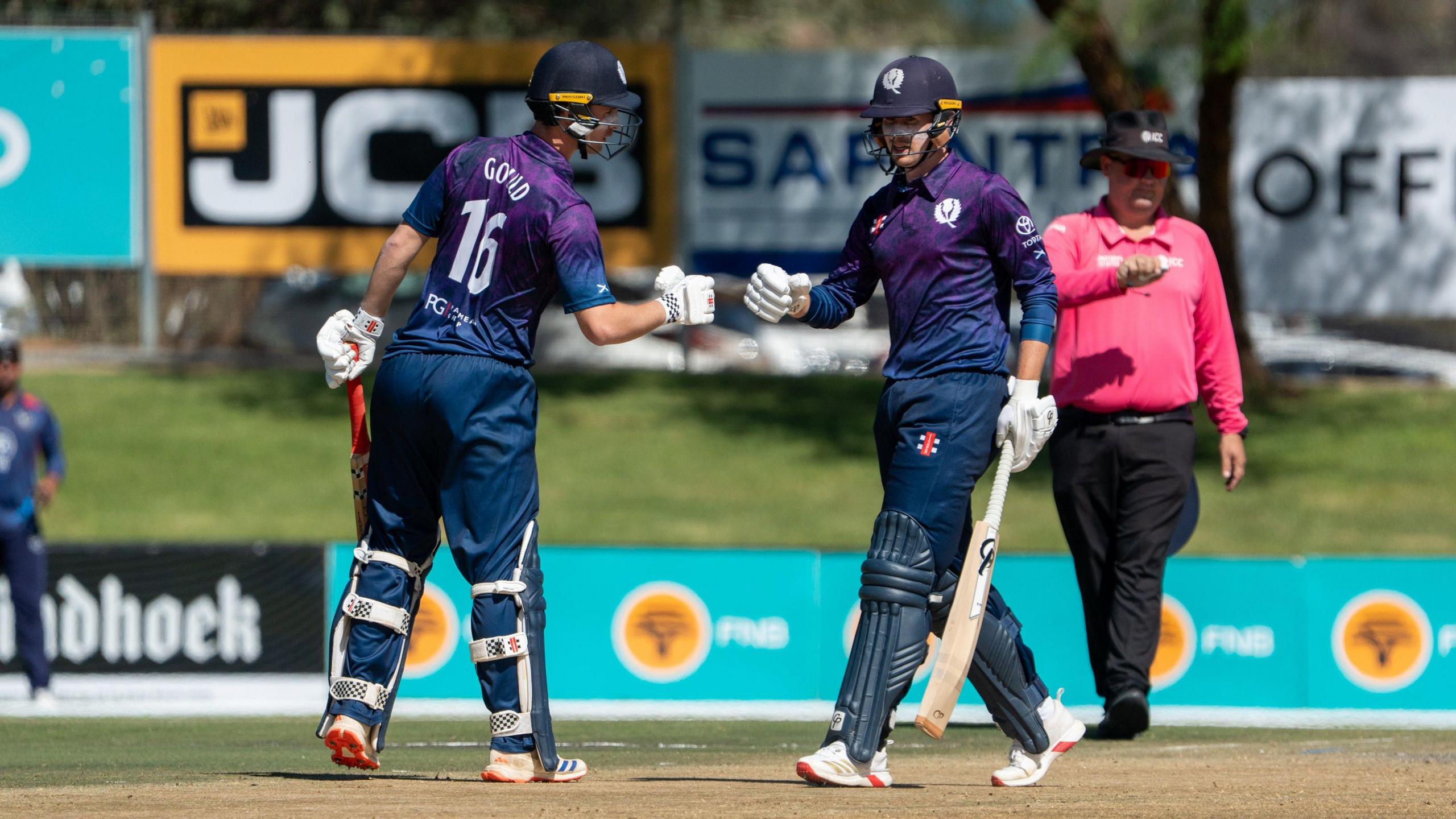 Owen Gould touches gloves with Brandon McMullen