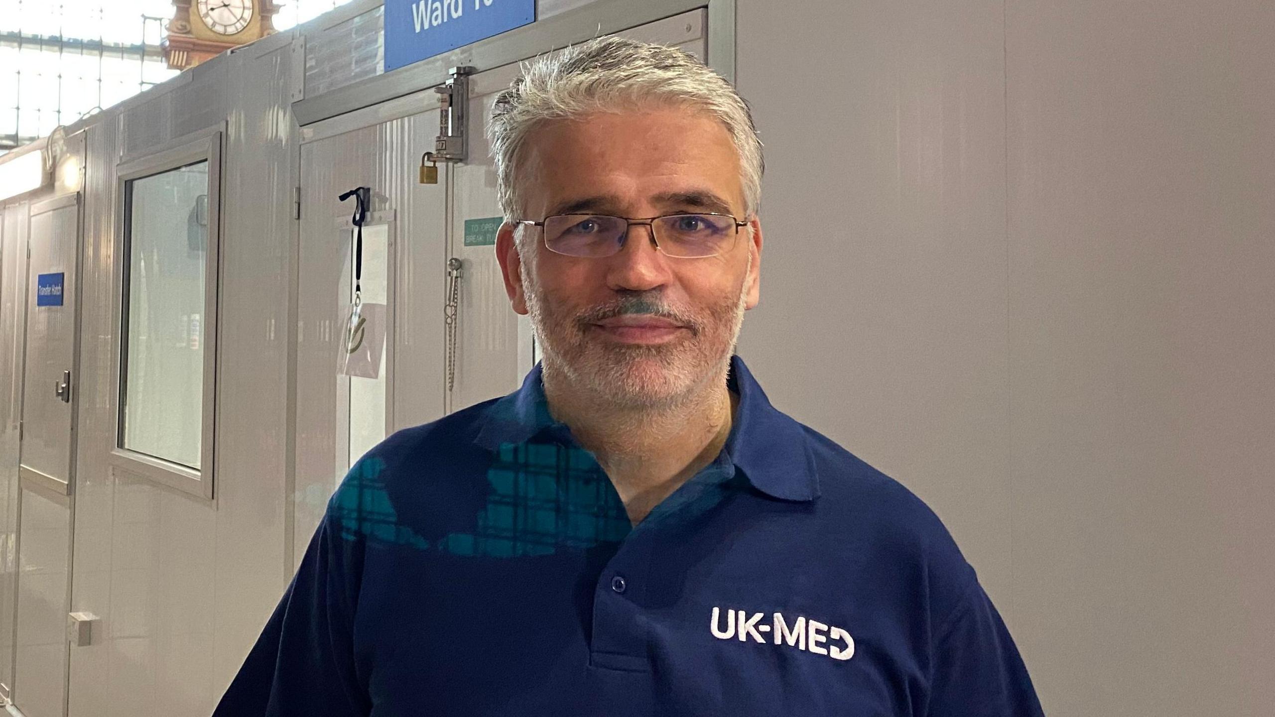 Image of David Anderson wearing a blue polo shirt with UK-MED on it