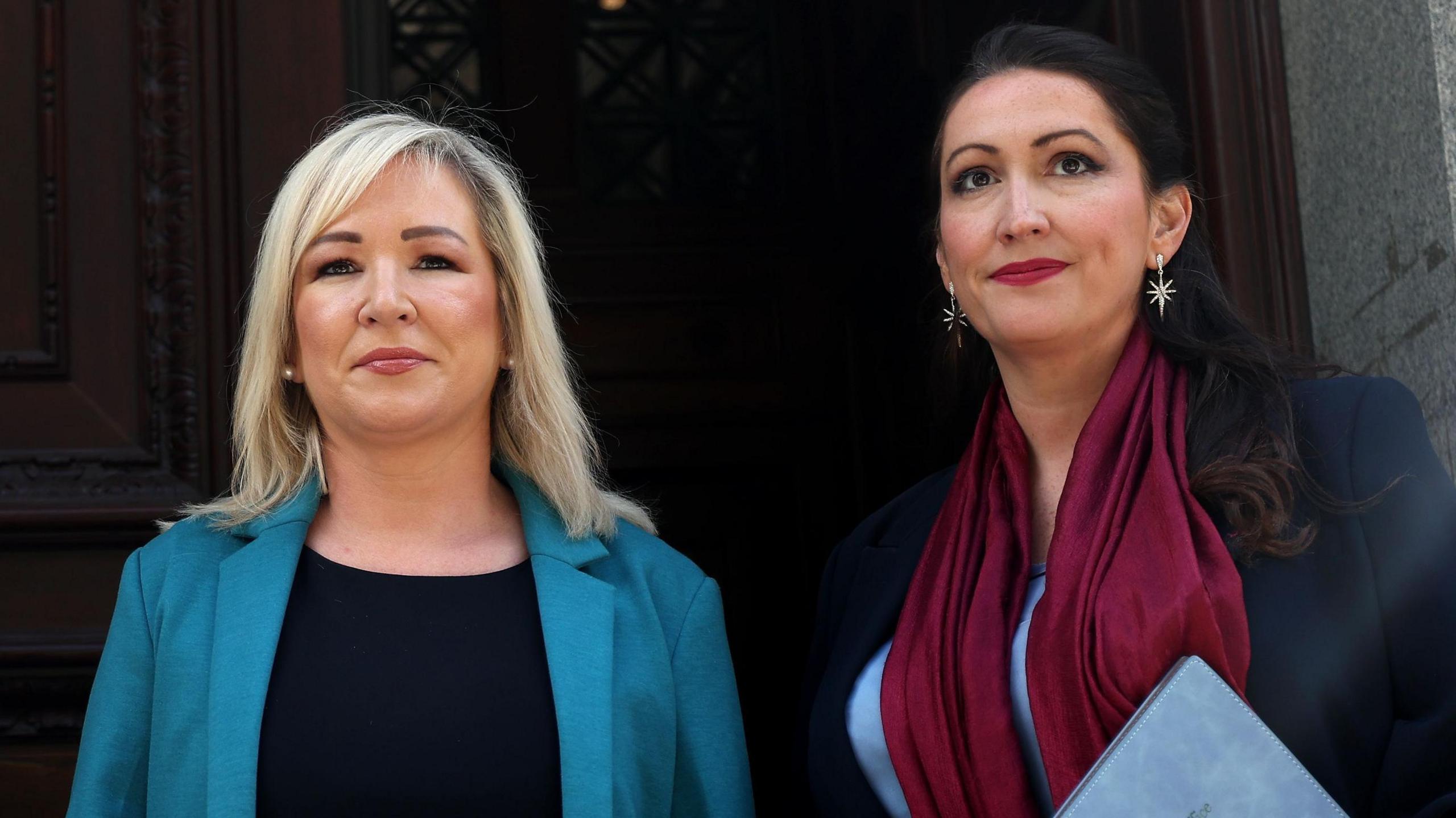 Archive photo of Michelle O'Neill and Emma Little-Pengelly in London in September.  Michelle O'Neiill has shoulder-length blonde hair and is wearing a turquoise blazer and a black dress.  Emma Little-Pengelly has long, dark hair and is wearing a claret-coloured scarf, a navy coat and a light blue top. 