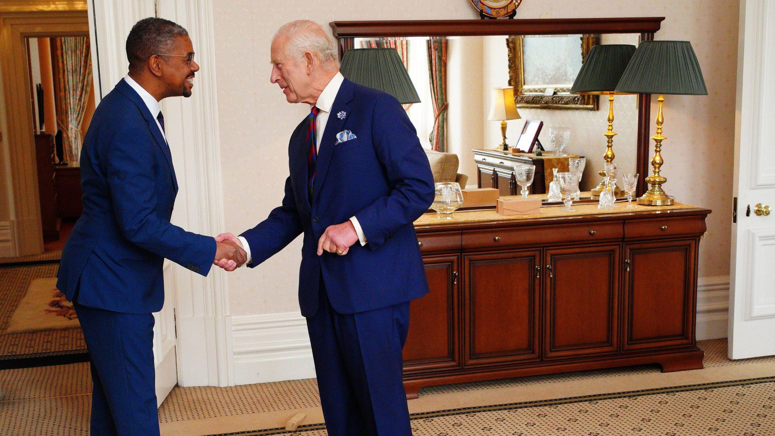 Vaughan Gething shakes hands with King Charles III