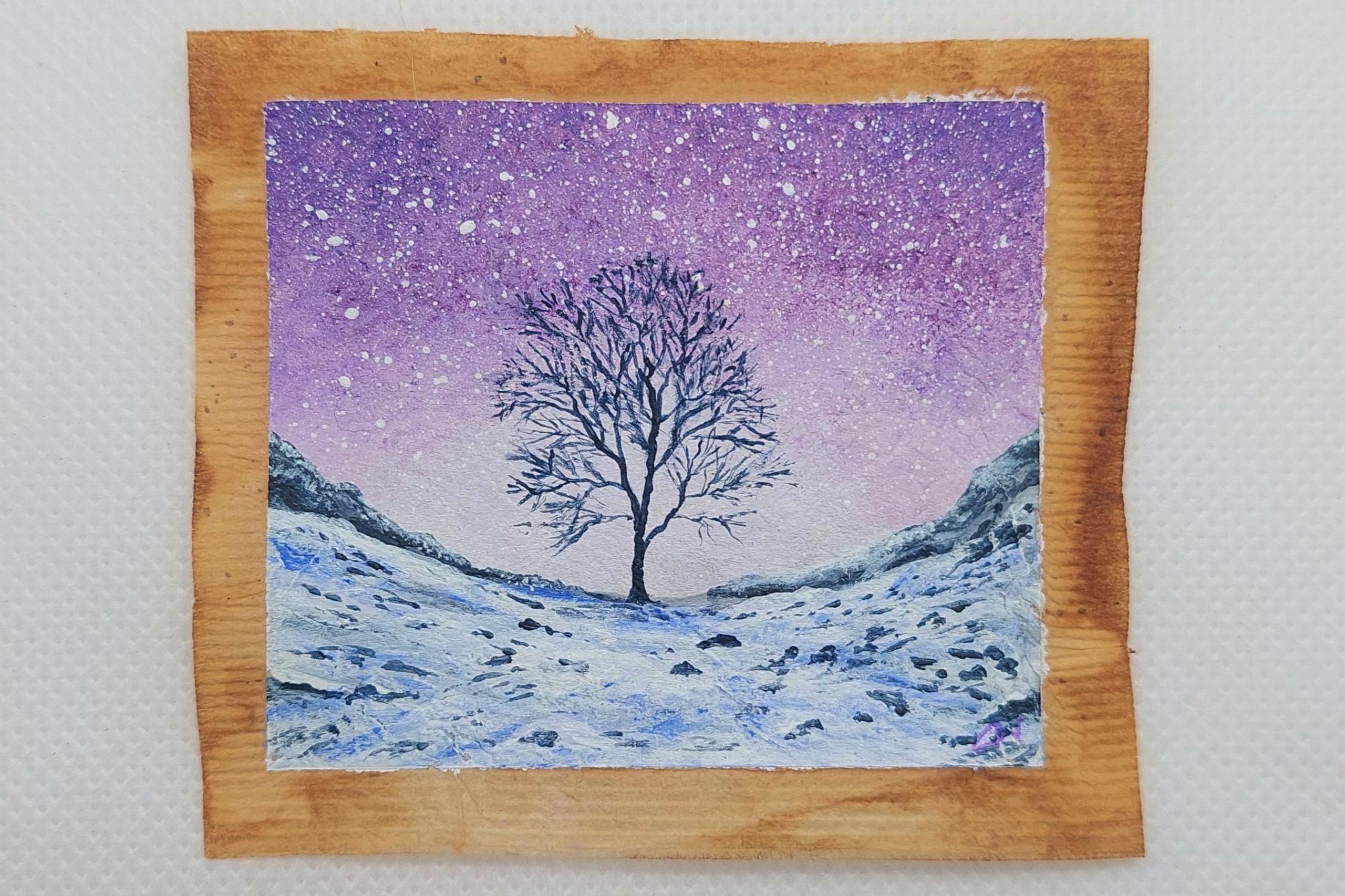 The Sycamore Gap tree on a used teabag painting in a Winter setting. Snow covers the ground, the sky is a purple colour.