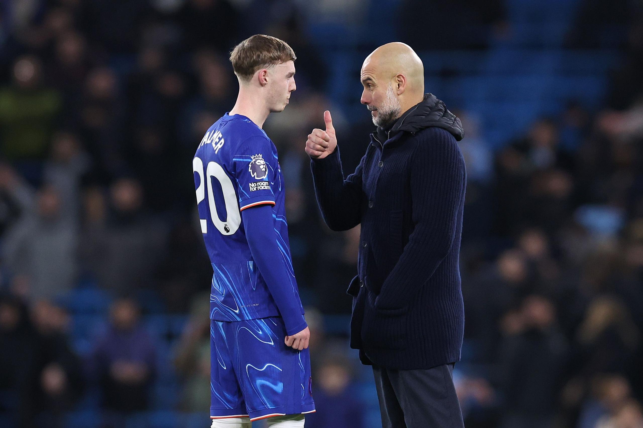 Pep Guardiola the manager of Manchester City talks with Cole Palmer of Chelsea after the Premier League match between Manchester City and Chelsea at Etihad Stadium in Manchester, England