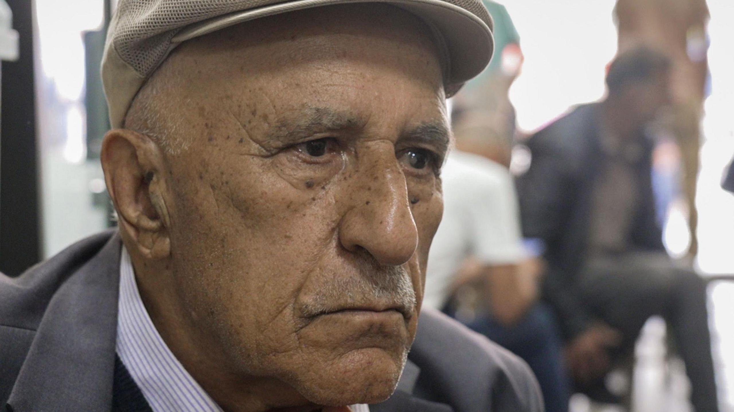 A headshot of Mehmet Ek wearing a cap. He looks to the right of the camera.