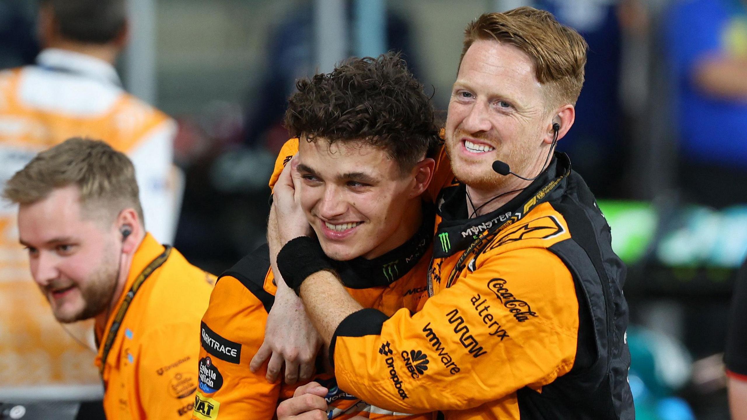 Lando Norris celebrates with a McLaren mechanic after winning the Abu Dhabi Grand Prix