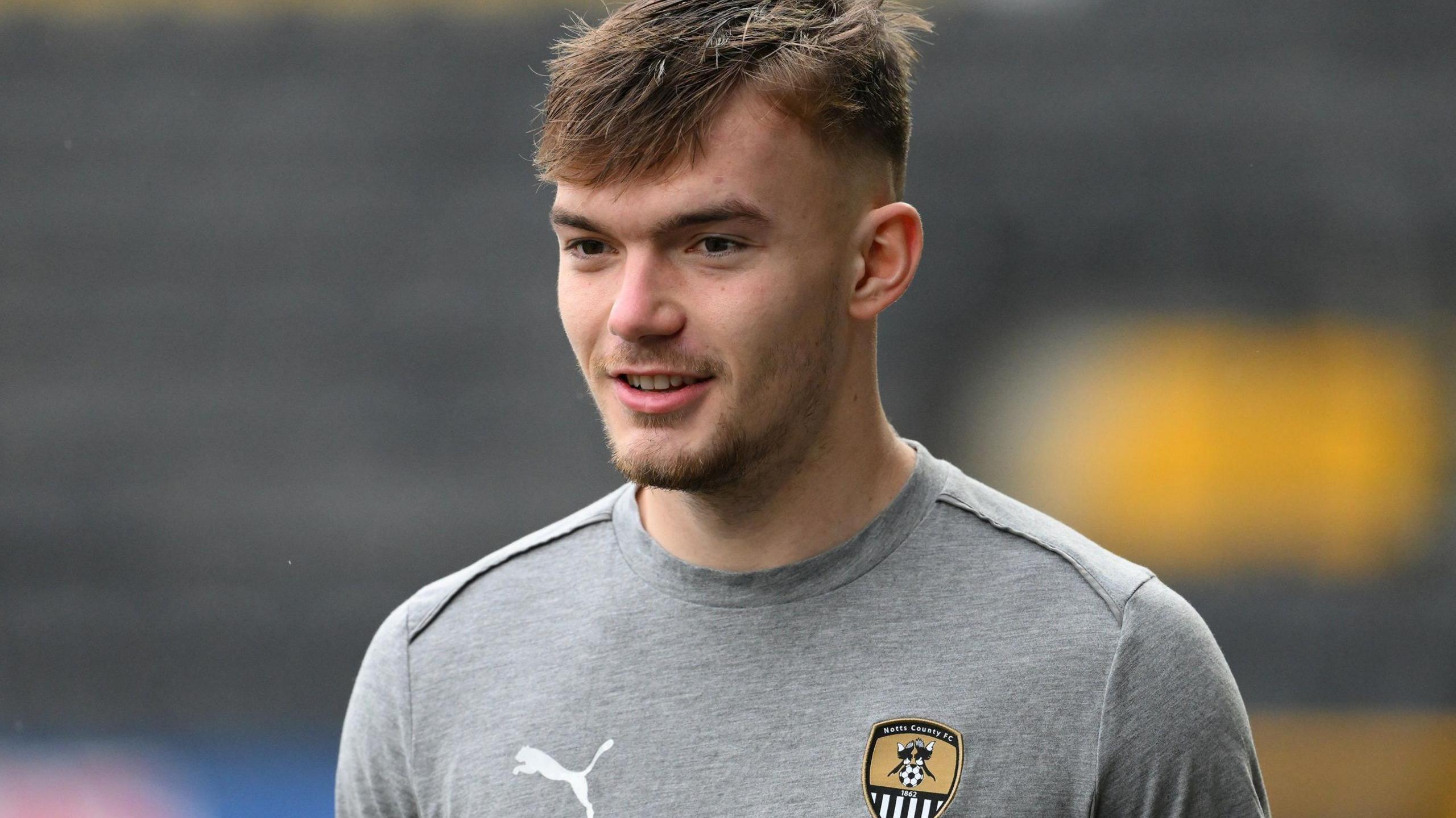 Lewis Macari warming up for Notts County