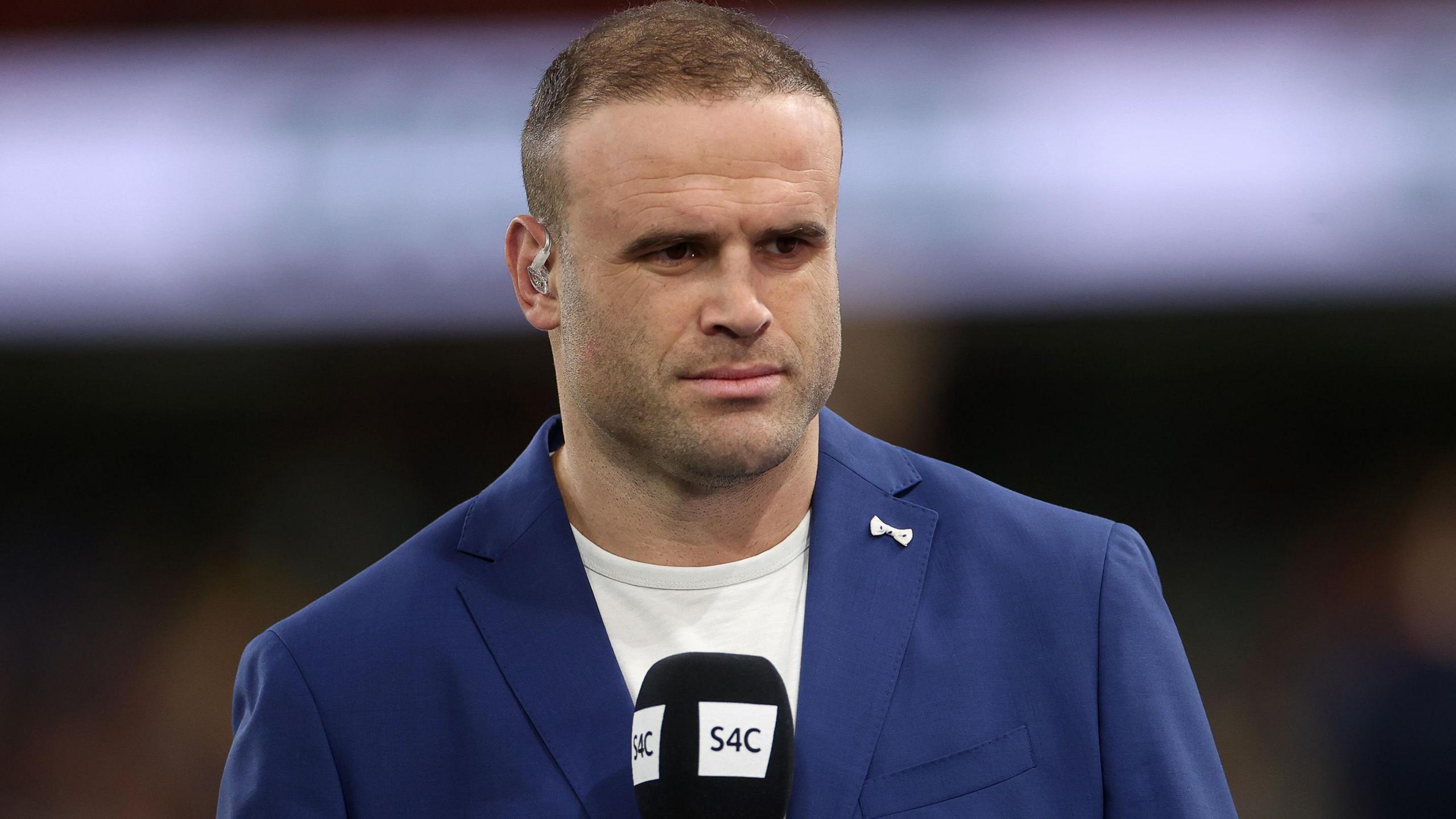 Jamie Roberts with a microphone in his hand