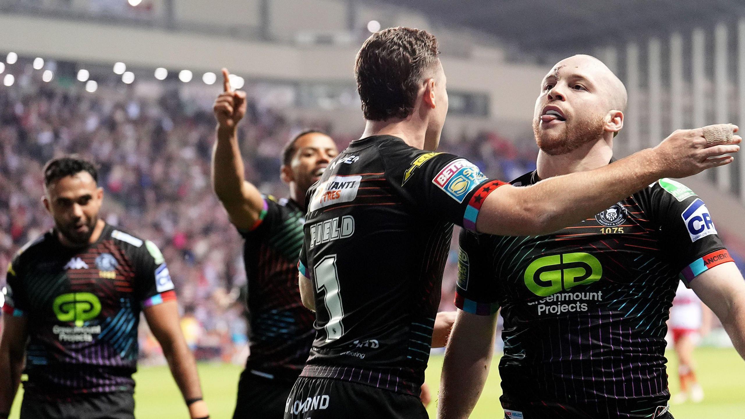 Wigan's Liam Marshall celebrates with Jai Field after scoring a try against Hull KR