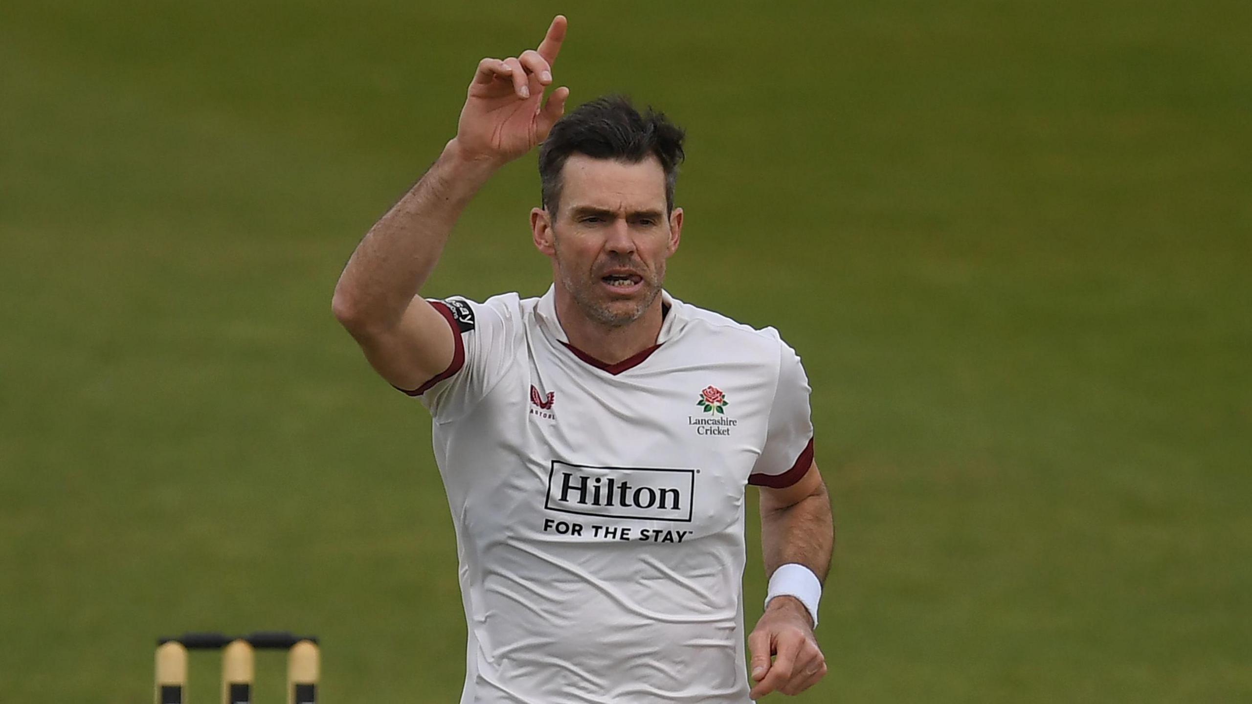 Sir James Anderson takes a wicket and celebrates with his right hand in the air