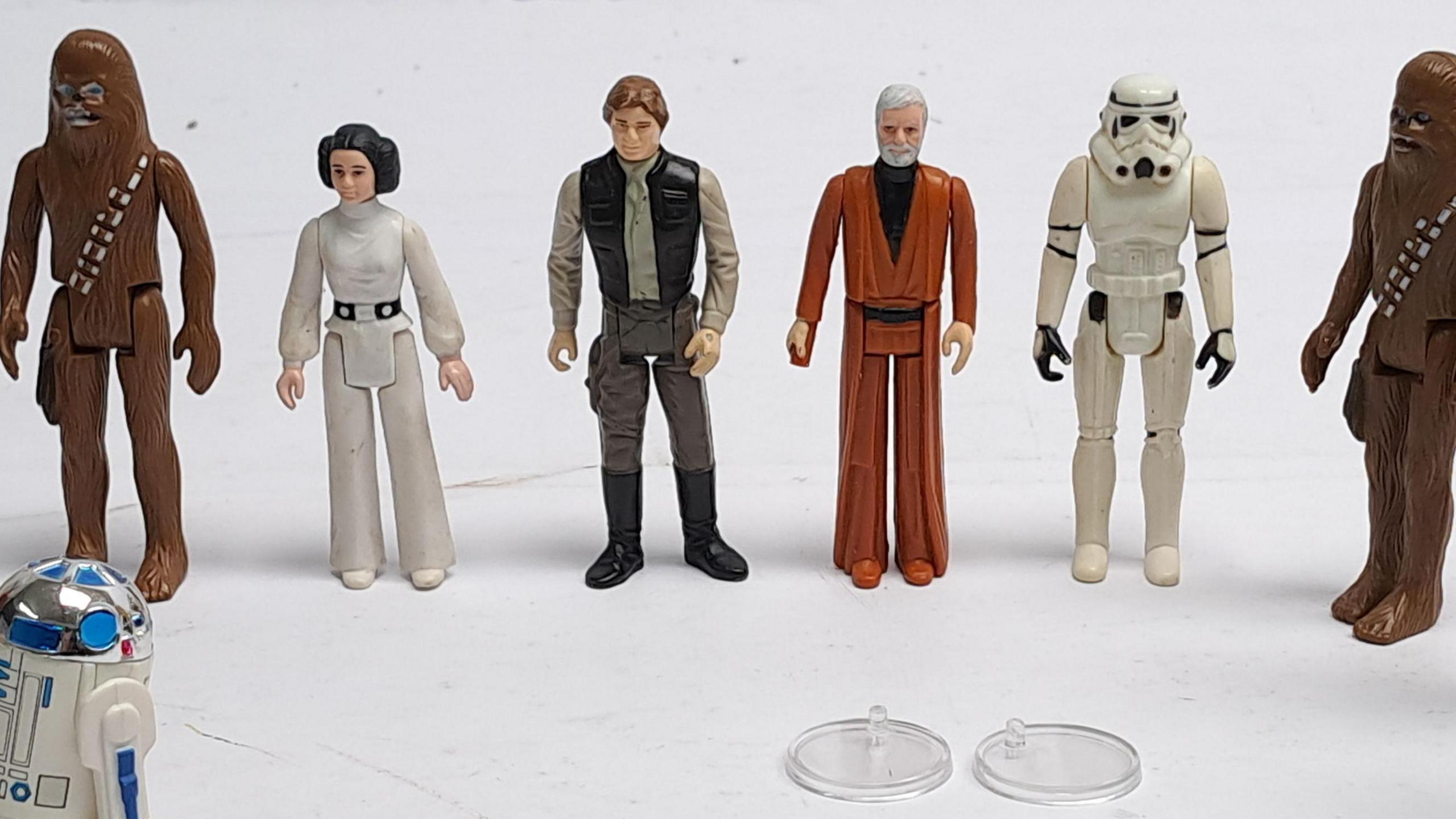 A collection of six Star Wars figurines, including Chewbacca, a Stormtrooper and Princess Leia