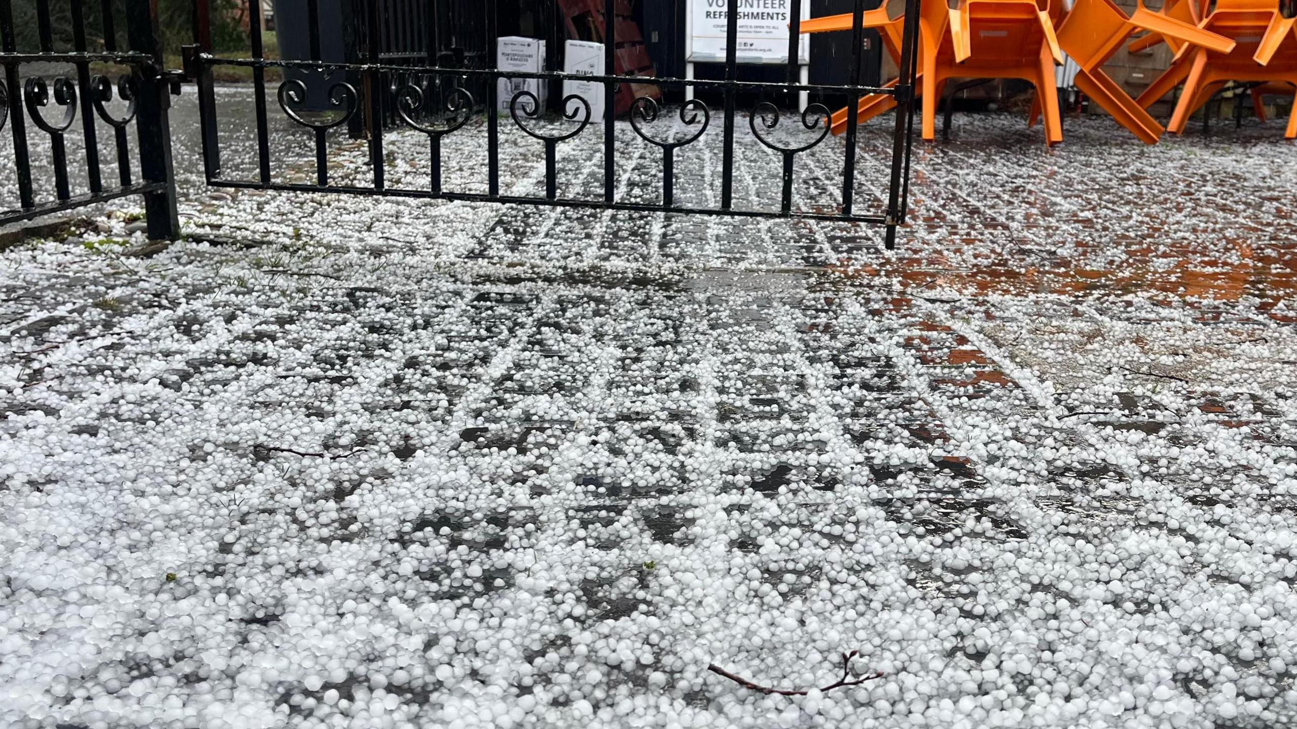 Hail covers a paved area in Hertford