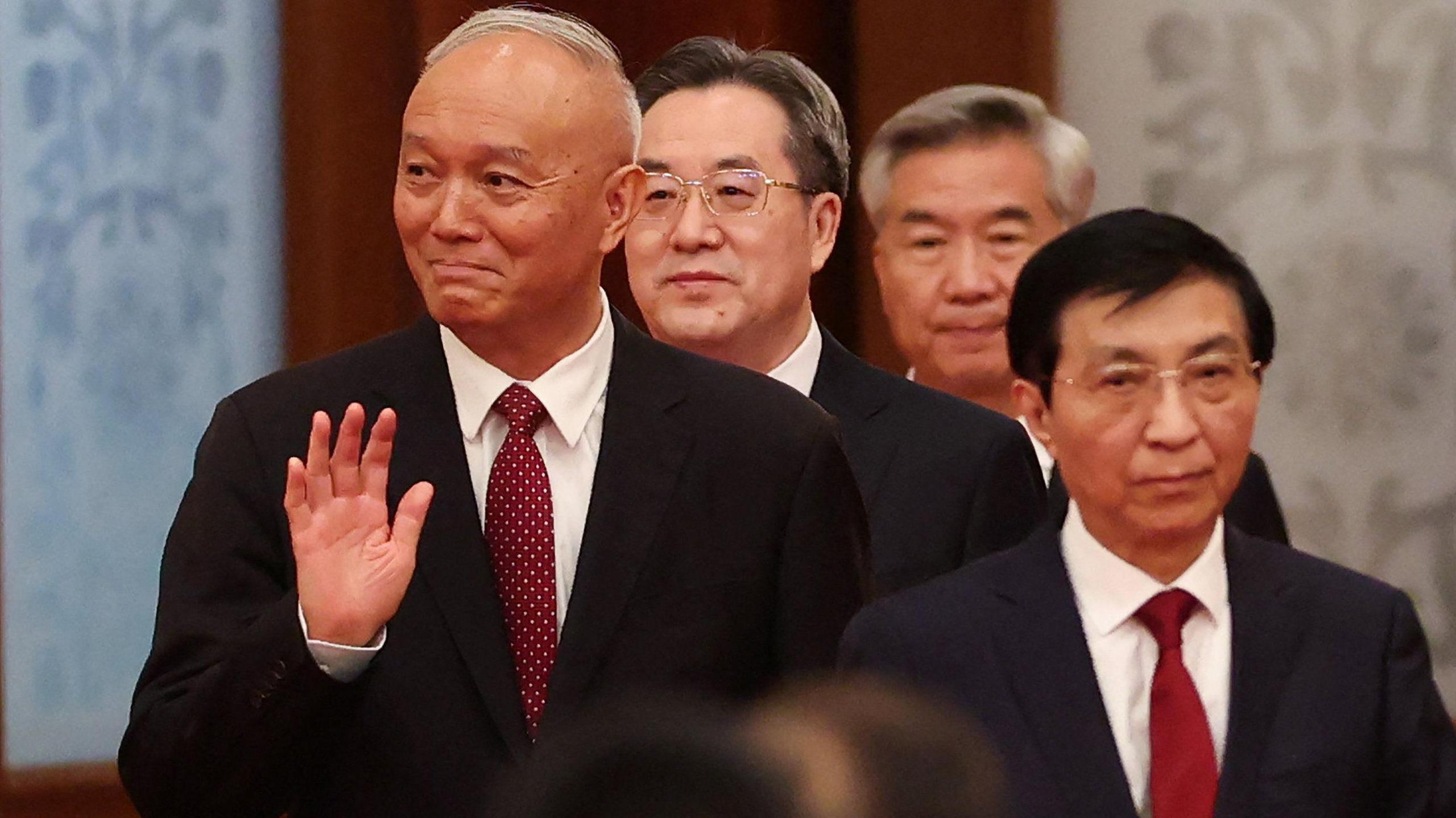 Chinese Politburo Standing Committee member Cai Qi waves as he enters the hall together with China’s Vice Premier Ding Xuexiang, Chinese Politburo Standing Committee member Li Xi, and Chinese People's Political Consultative Conference (CPPCC) Chairman Wang Huning.
