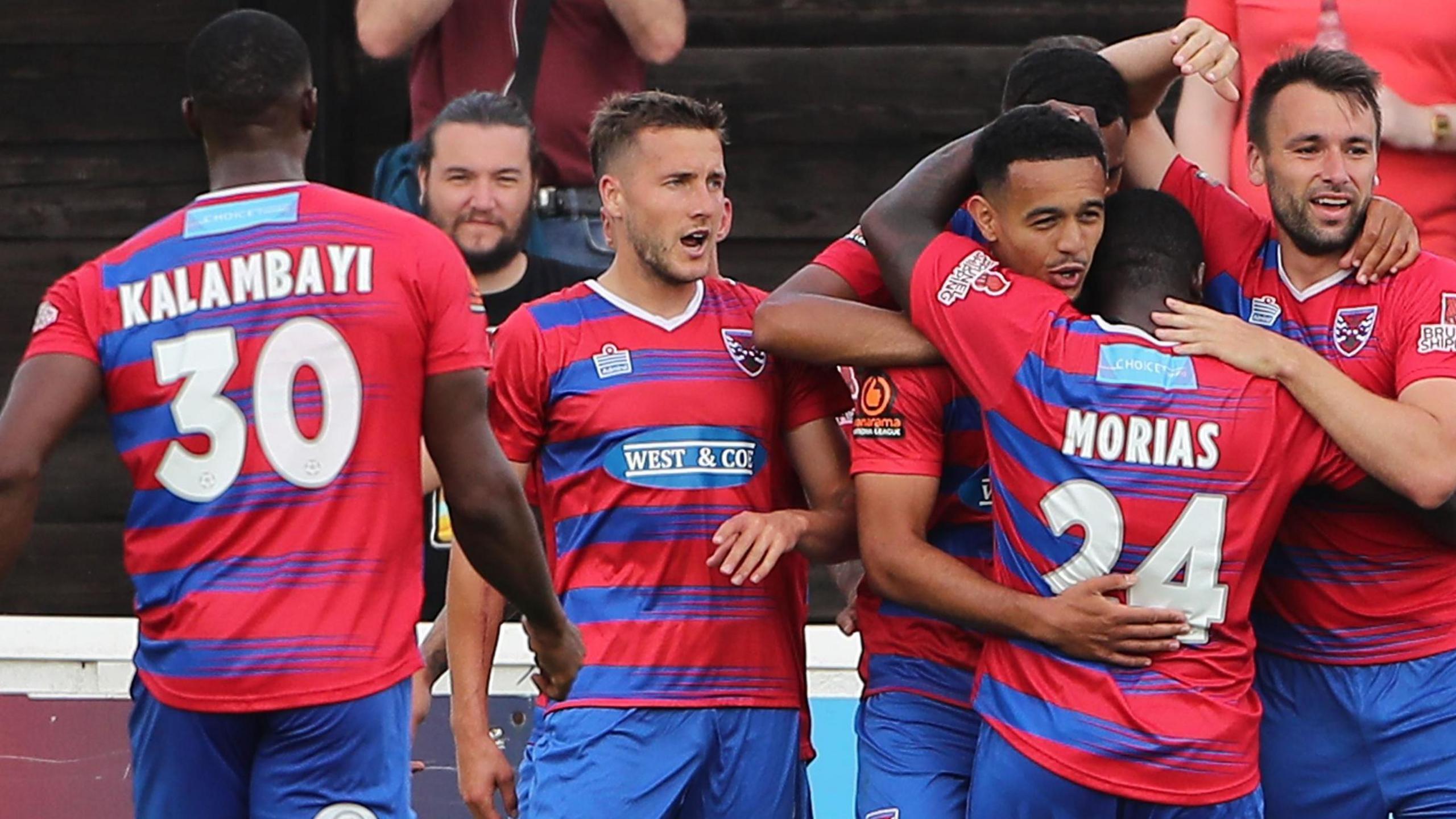 Dagenham & Redbridge's players celebrate scoring a goal