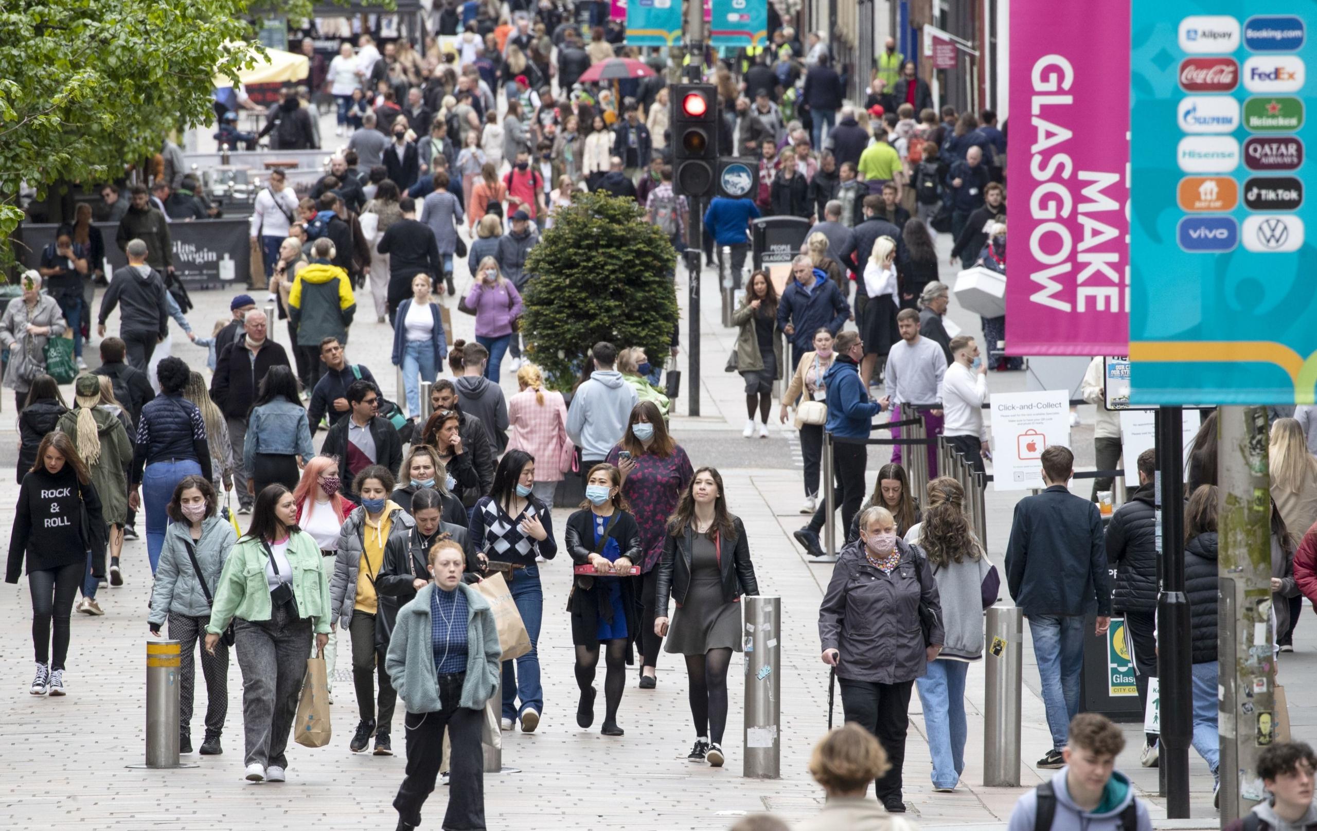 Crowds of shoppers walking up and down Glasgow's Buchanan Street during daylight hours