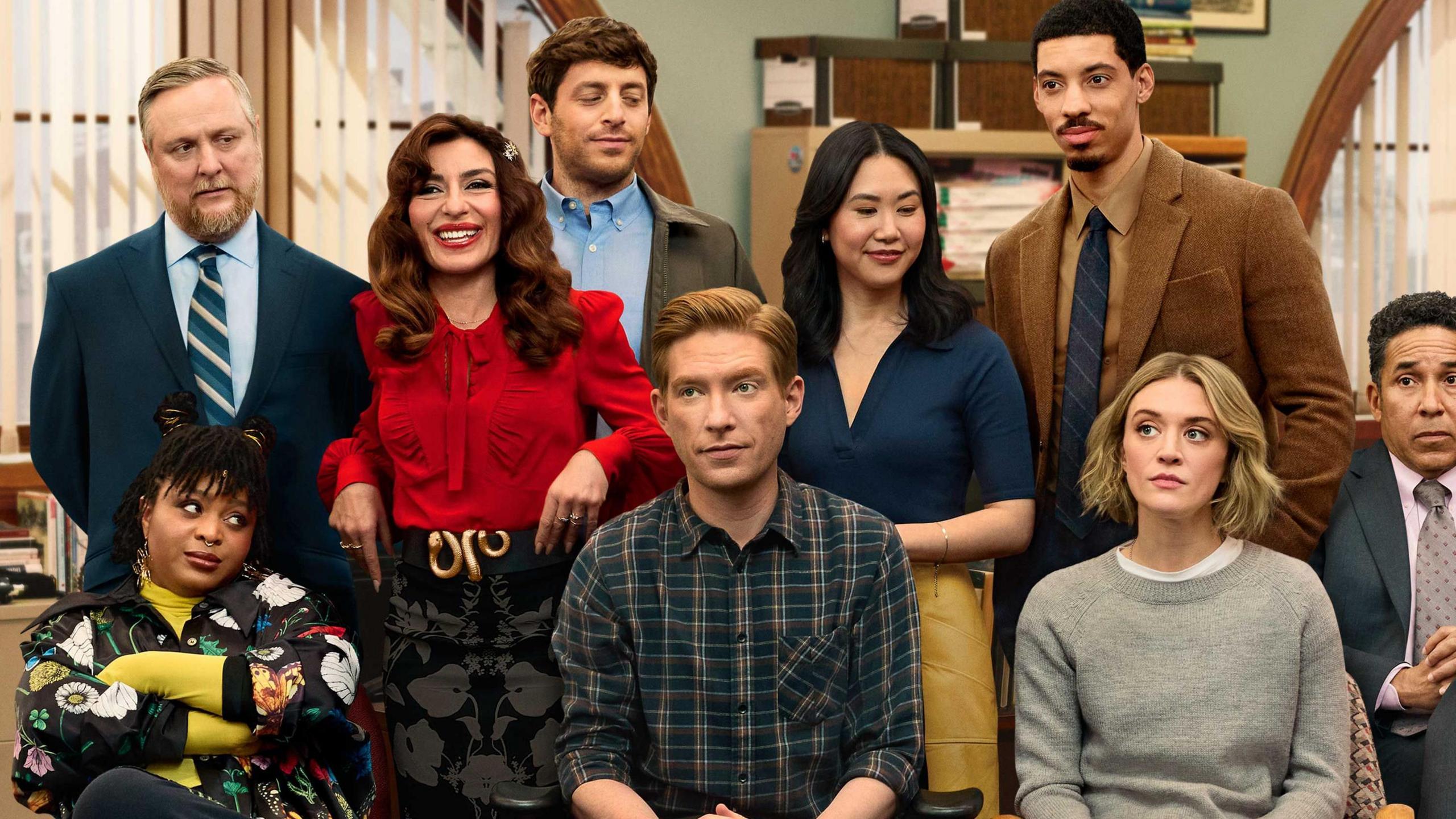Cast of The Paper gathered together in a newsroom