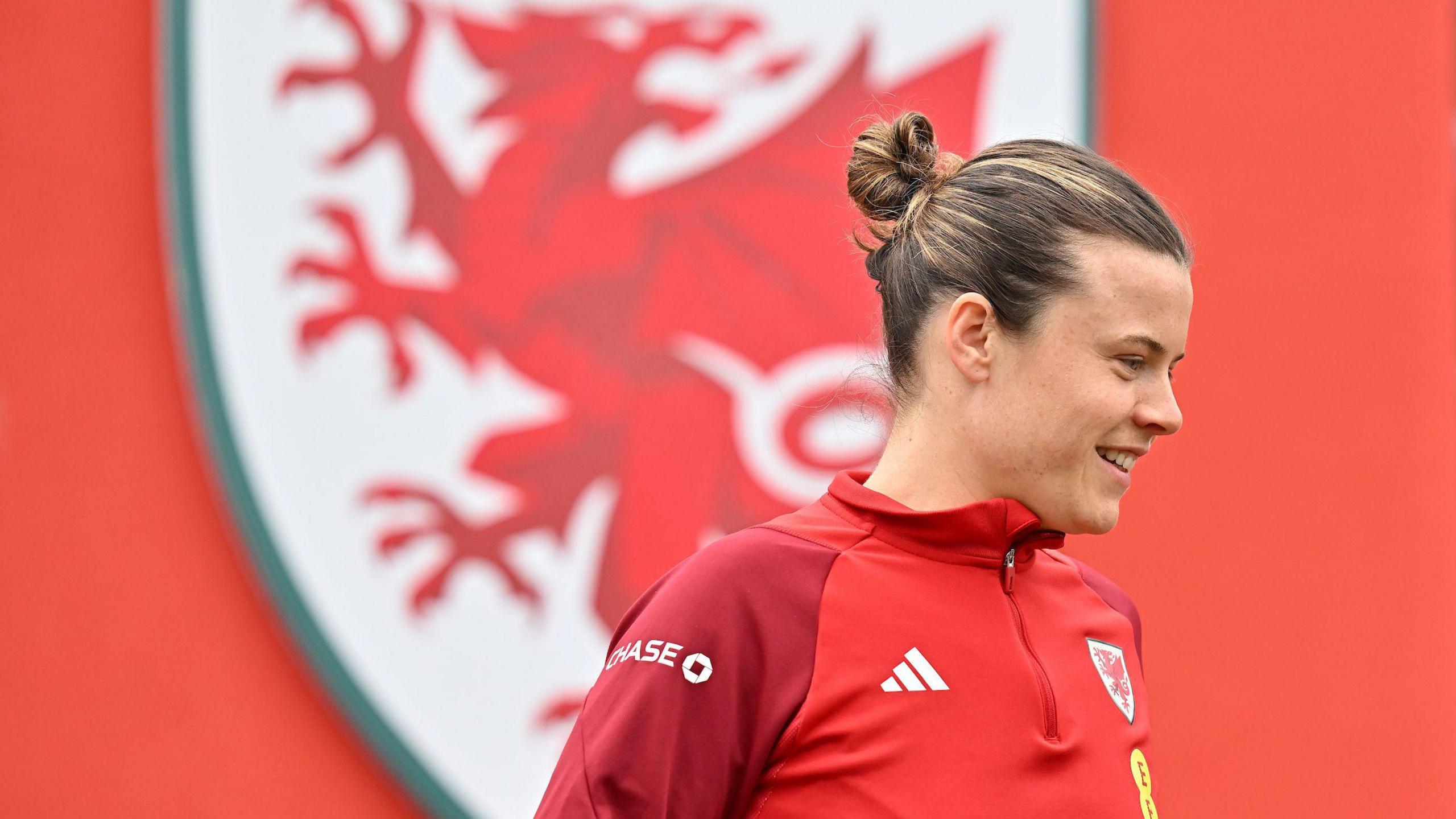 Hayley Ladd in front of Wales badge