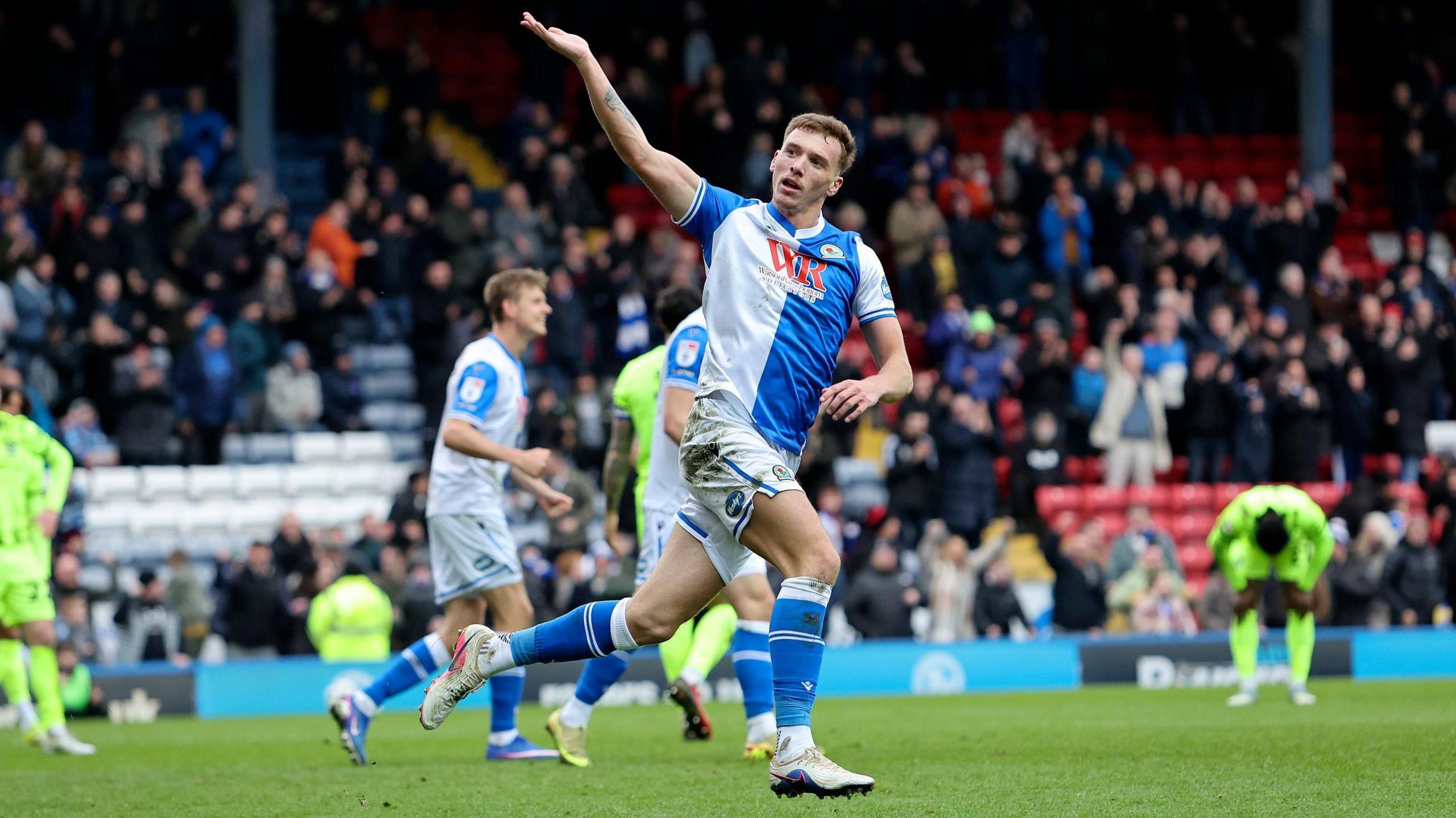 Hayden Carter celebrates with his hand aloft after scoring for Blackburn Rovers