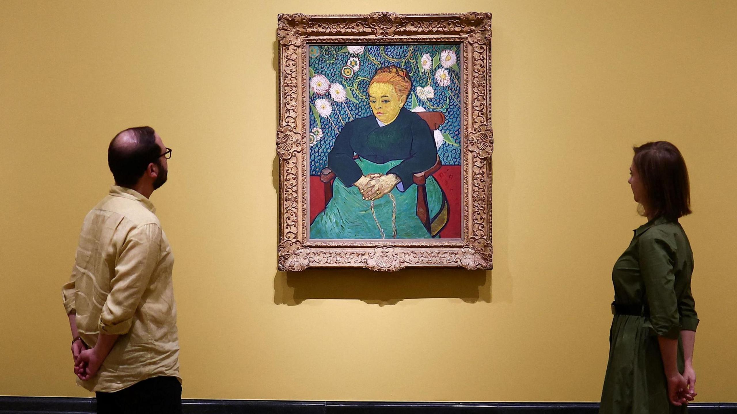 Two of Van Gogh's Sunflowers paintings, with La Berceuse in the centre, in the National Gallery