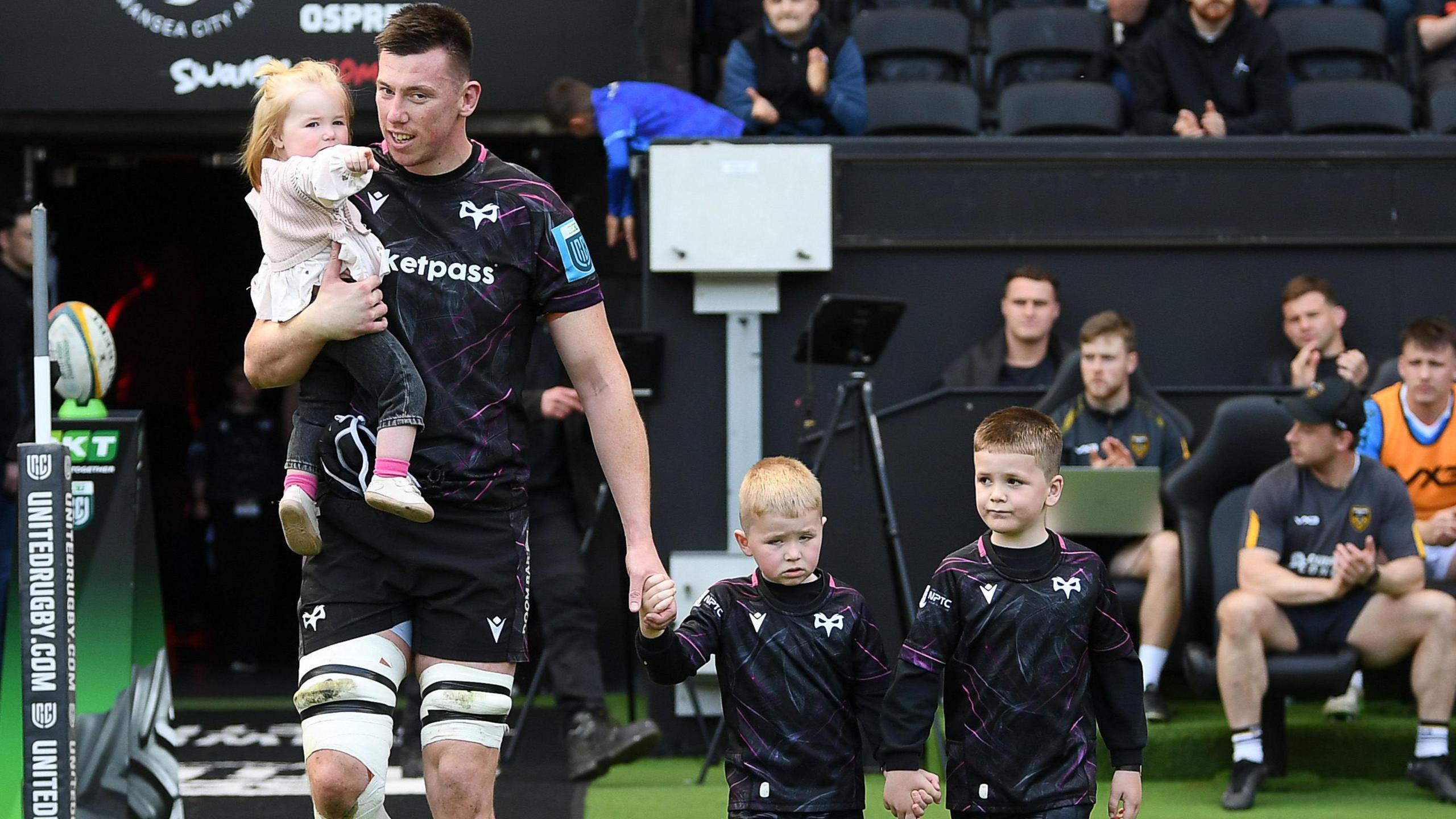 Wales lock Adam Beard leads the Ospreys out with his children by his side