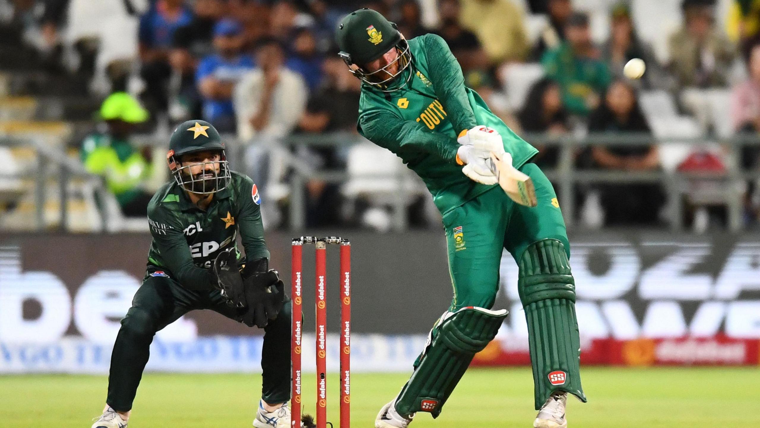 South Africa's Heinrich Klaasen plays a shot as Pakistan's Muhammad Rizwan watches on