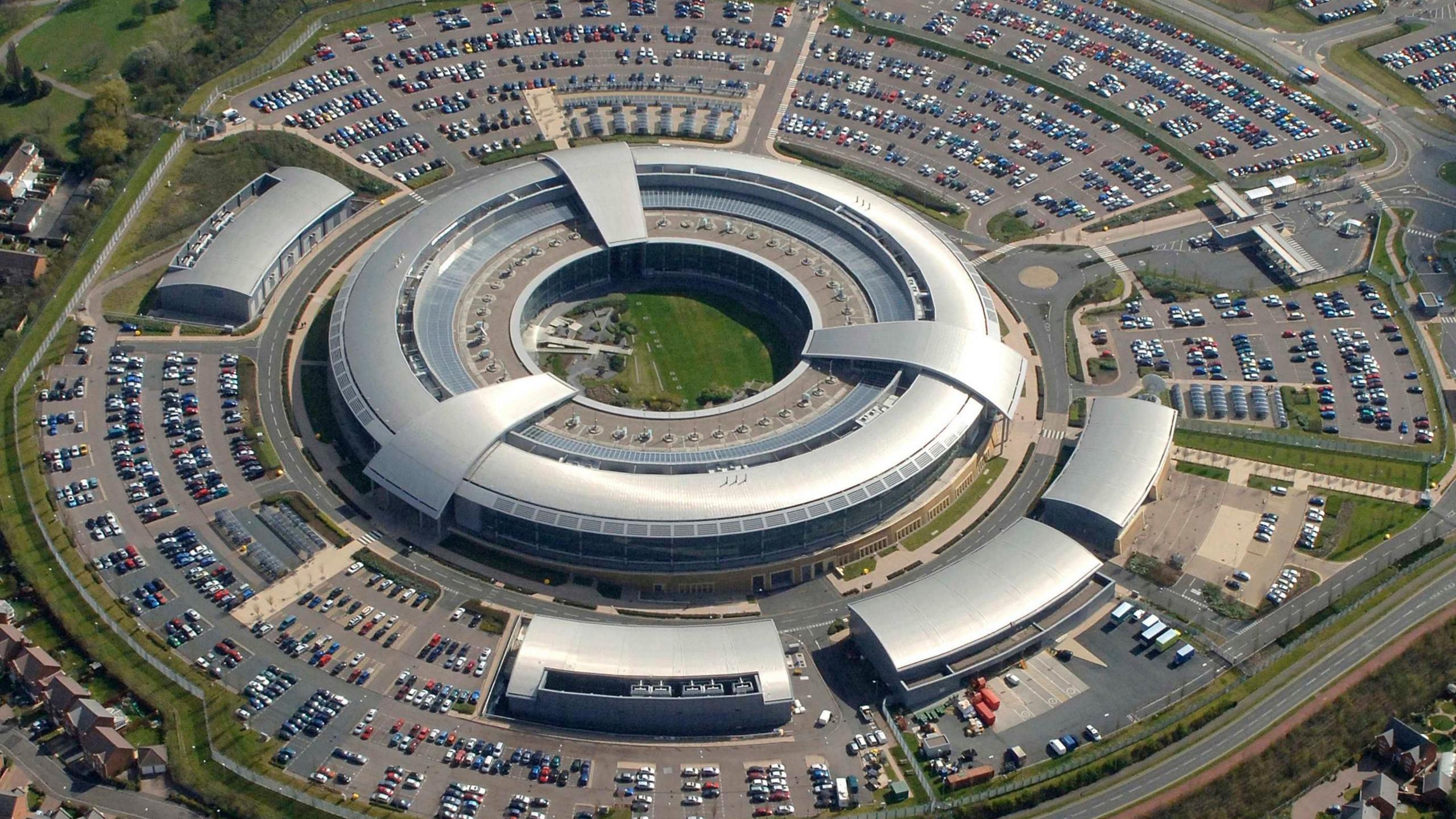 An Aerial view of the GCHQ site, known as the donut because of it's spherical shape with a hole in the middle. Many cars are seen parked on the exterior