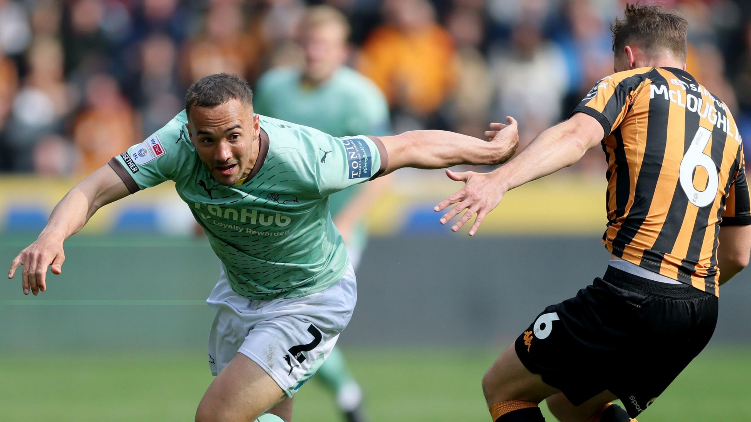 Derby County's Kane Wilson takes on Hull City's Sean McLoughlin