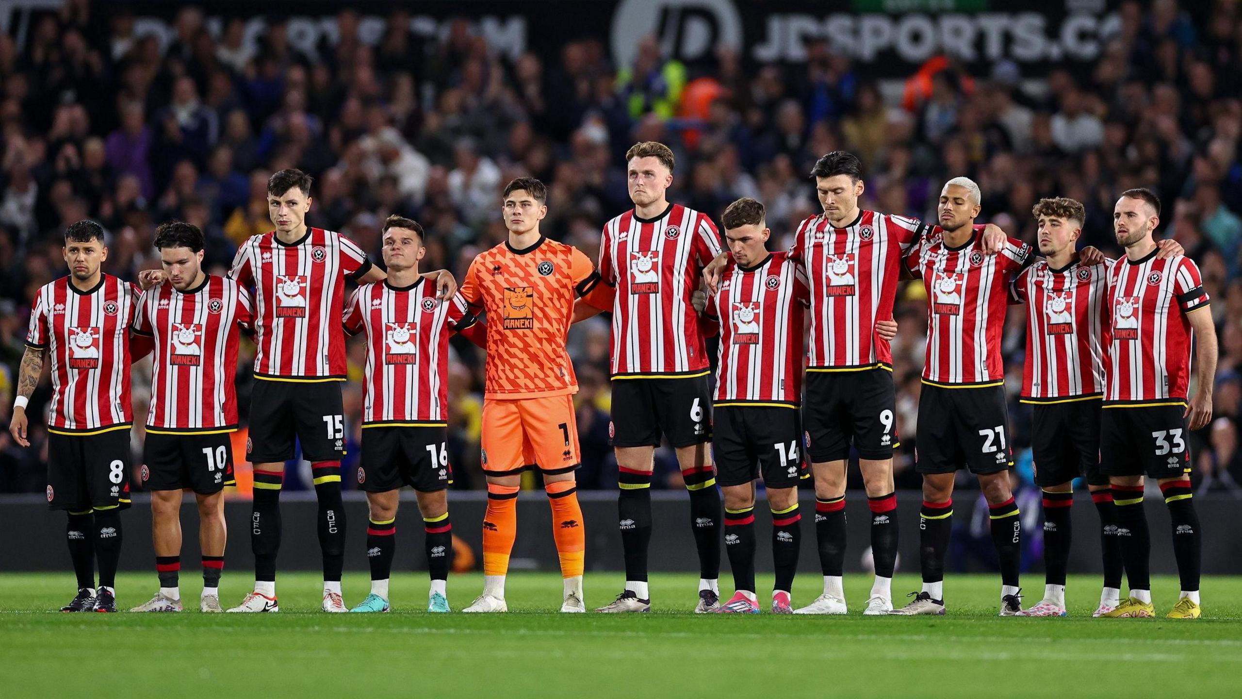 Sheffield United's players stand during the minute's applause at Elland Road for George Baldock