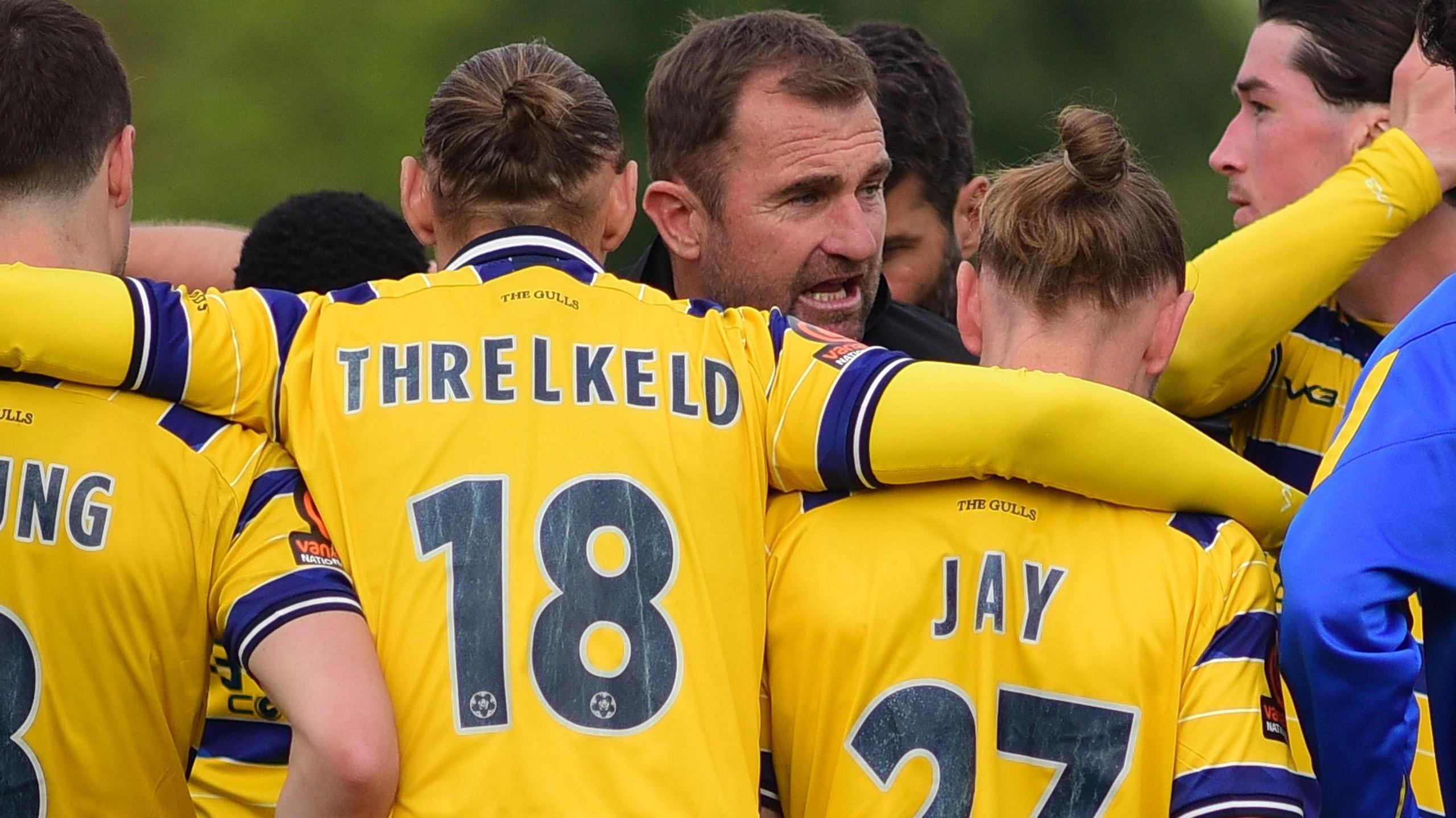 Paul Wotton conducts a team talk with his Torquay squad