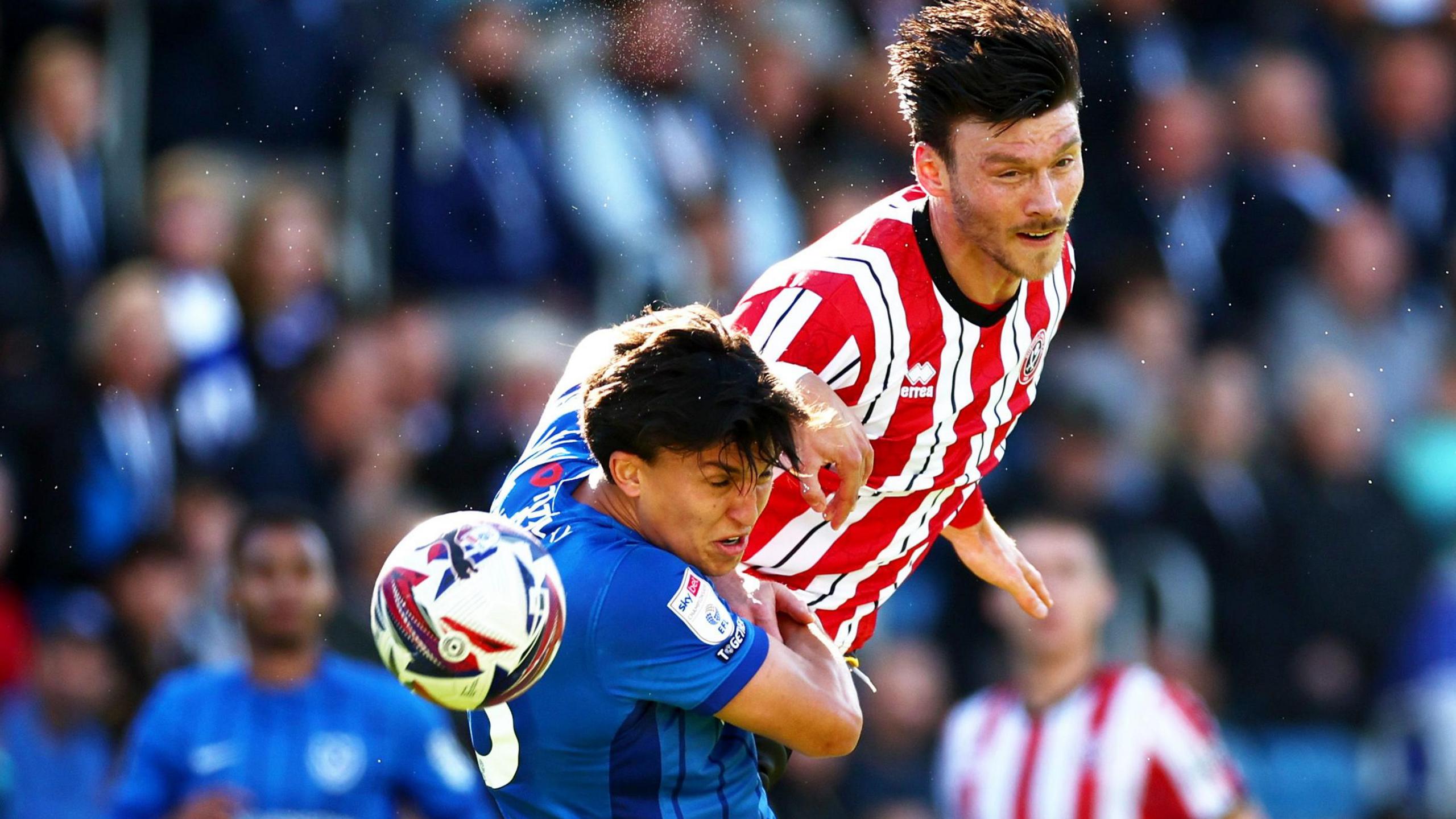 Sheffield United striker Kieffer Moore wins a header against Portsmouth 