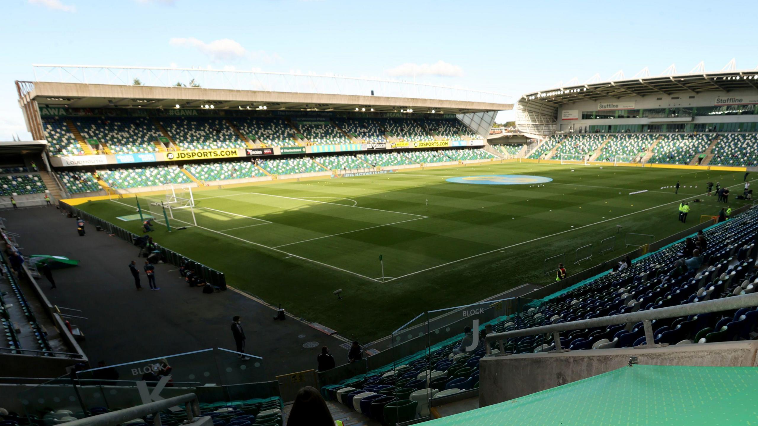 Archive photo of Windsor Park football stadium in Belfast in 2022.  The picture shows a wide view of the pitch and the stands taken from one of the terraces on a sunny day. 