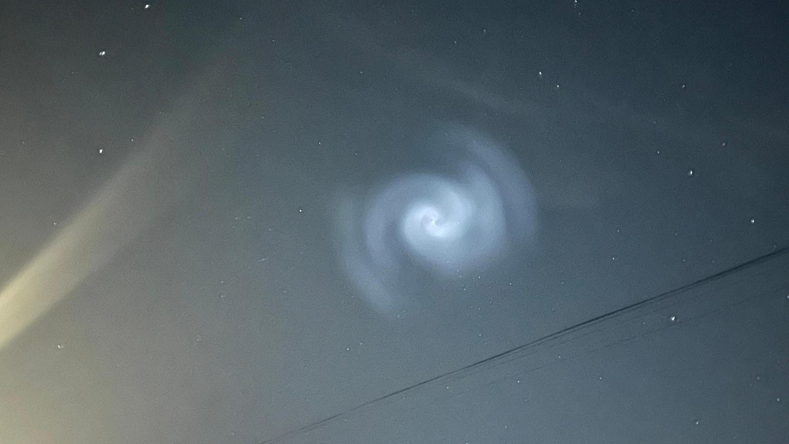 A spiral light in the sky seen over Riber in Derbyshire showing a ray of light from a nearby house or lamppost