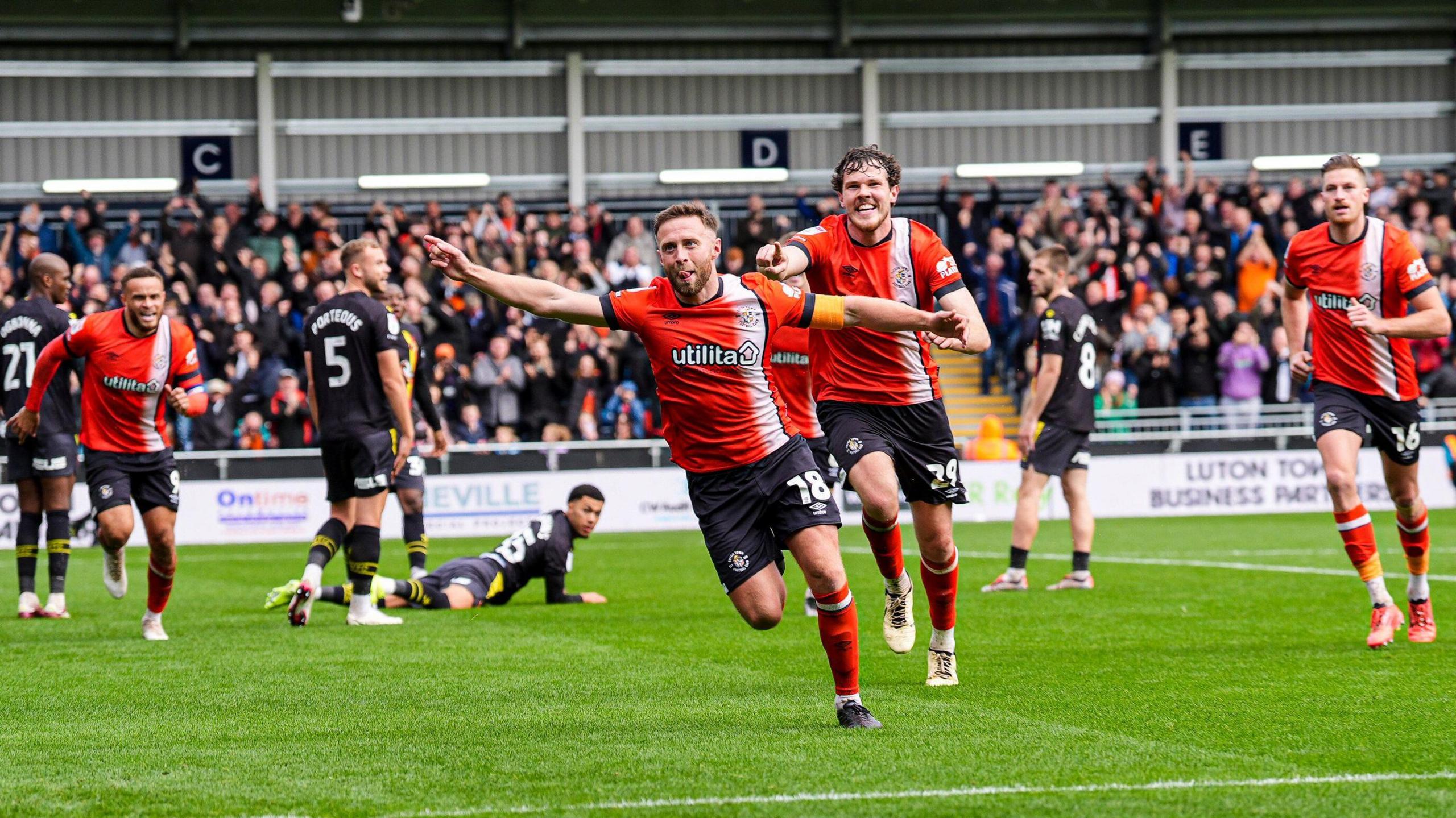 Footballers celebrating during a match between Luton Town FC and Watford FC