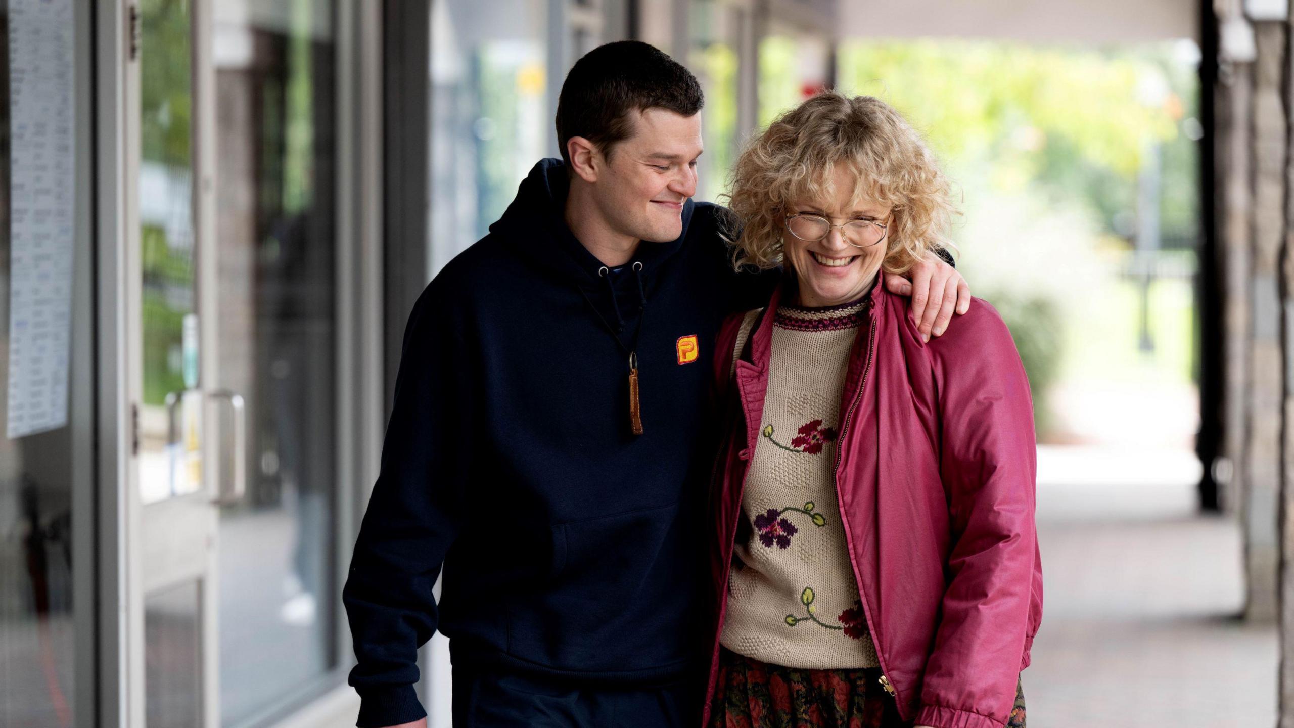 A still from the film of John and a woman in the street