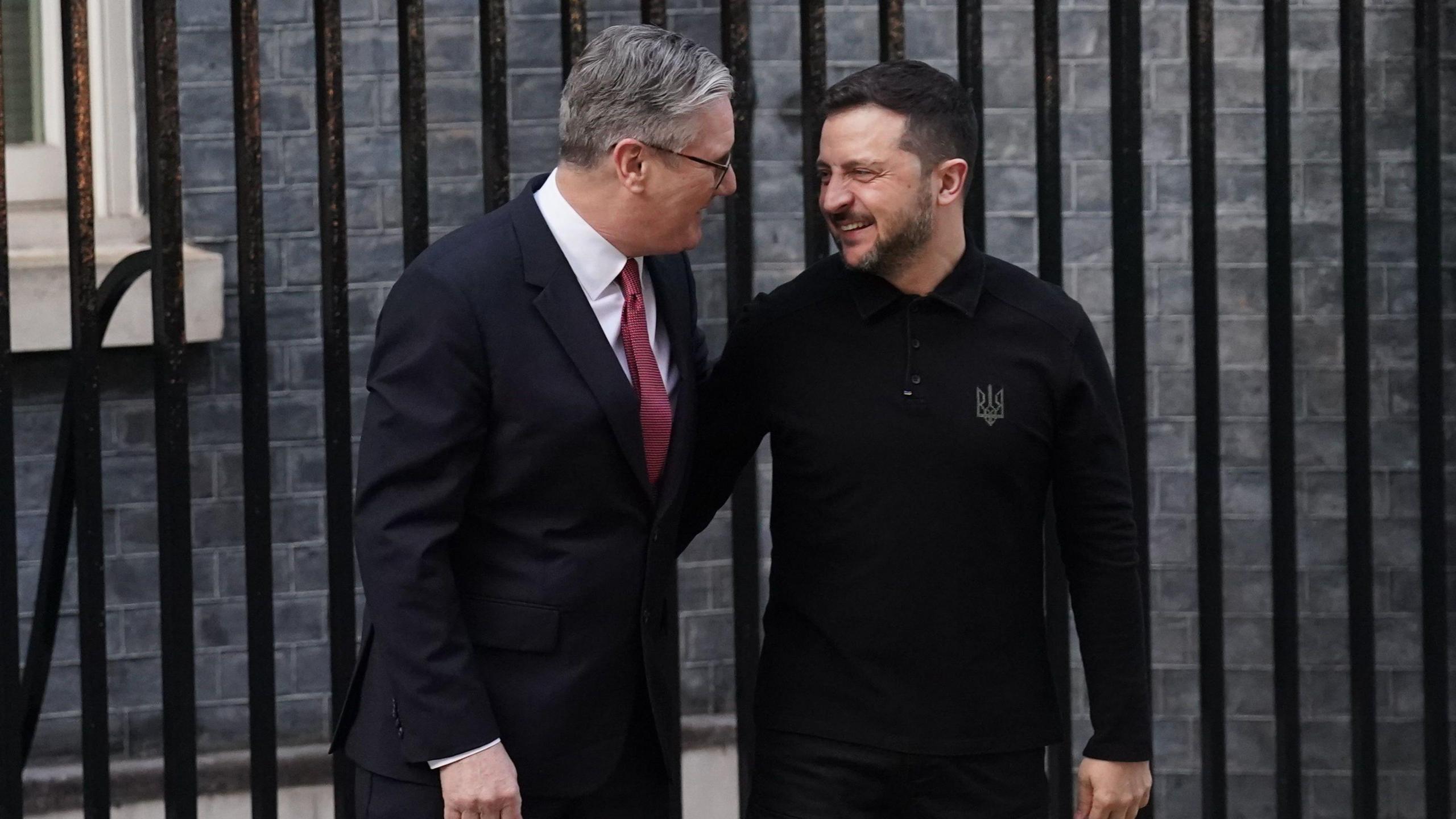 Prime Minister Keir Starmer and President Zelensky look at each other smiling outside Downing Street.