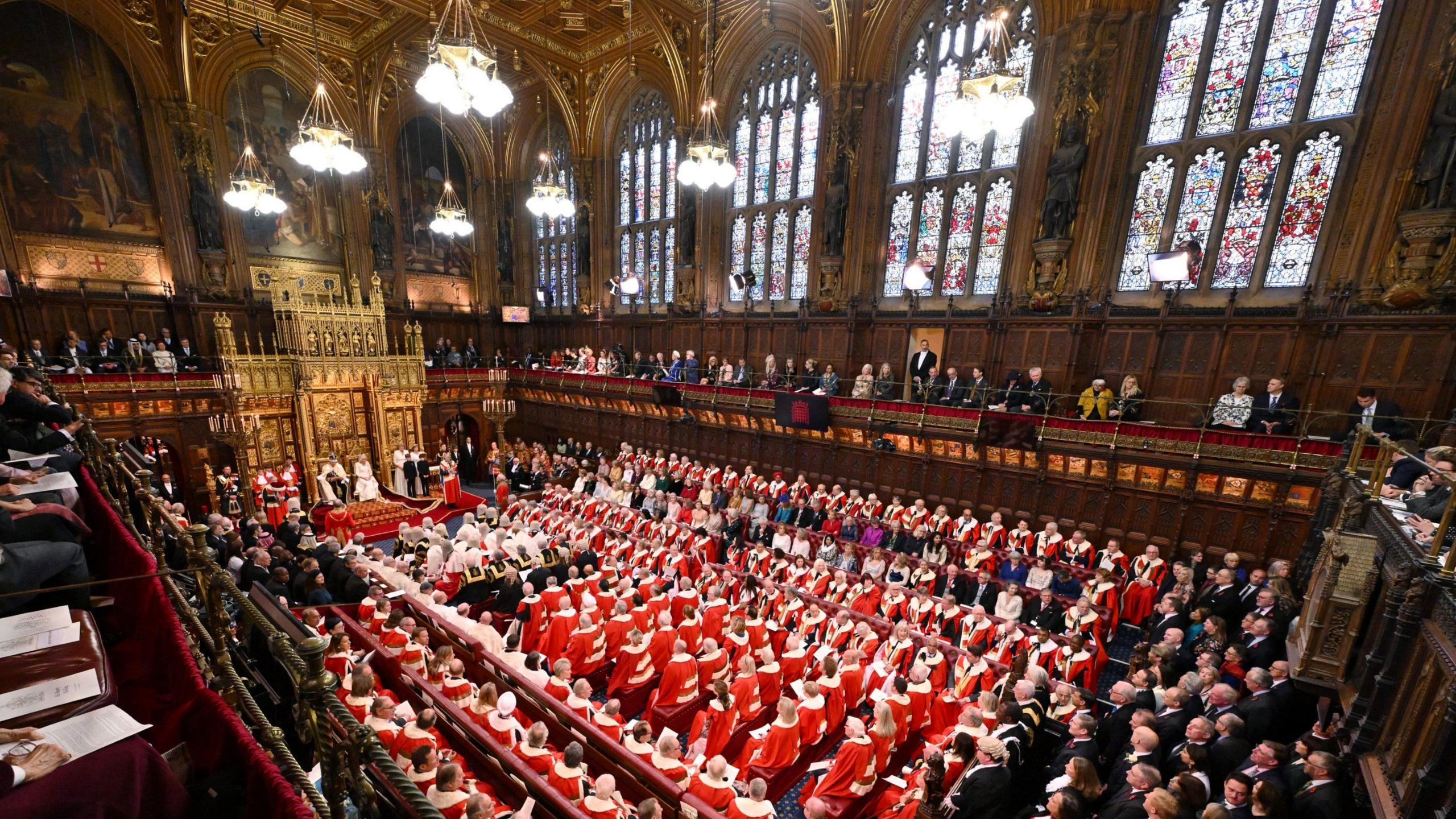 King Charles III delivers a speech beside Queen Camilla in 2023 during the State Opening of Parliament in the House of Lords at the Palace of Westminster in London