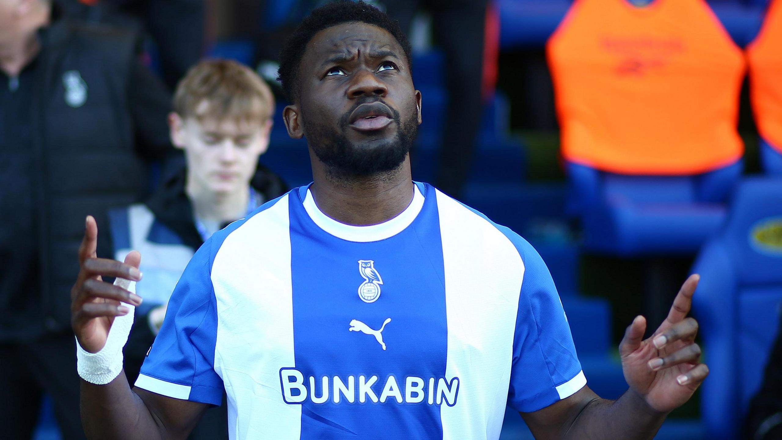 Oldham striker Mike Fondop looks to the sky with both hands raised