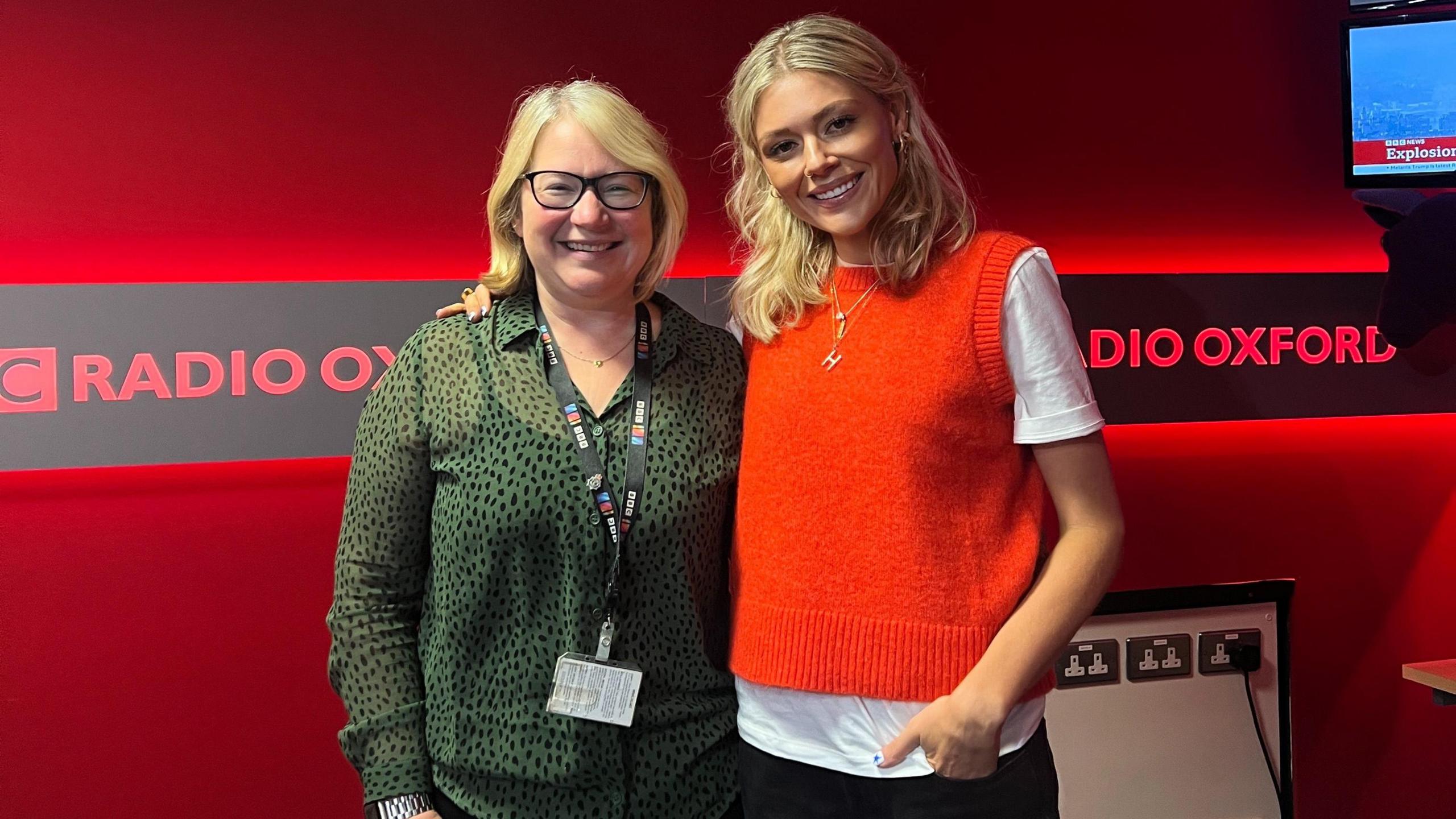 Hannah Viney with BBC Radio Oxford presenter Sophie Law in BBC Radio Oxford's studio. They are smiling for the camera