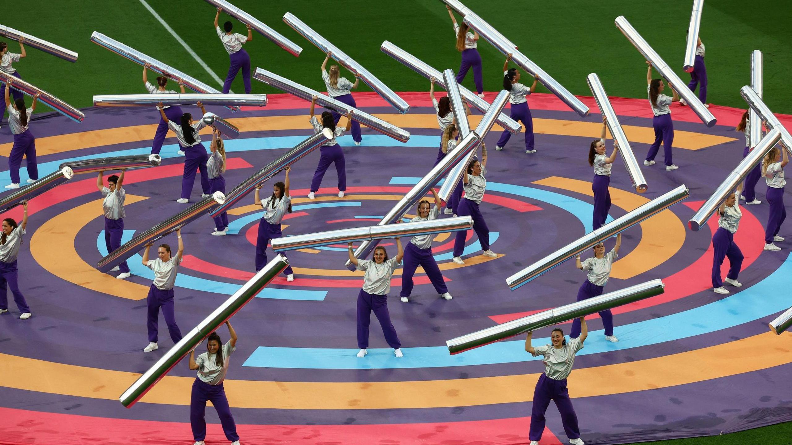dancers wave metal poles
