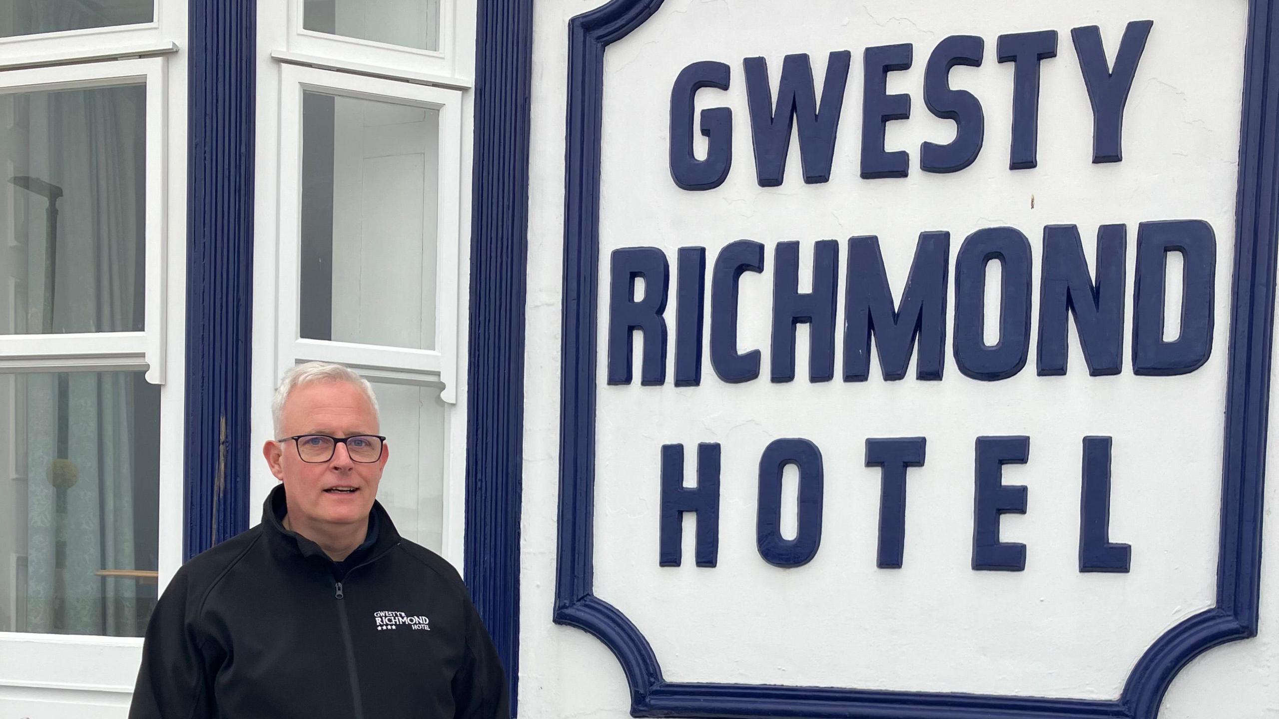  Richard Griffiths stood outside his hotel. The Richmond Hotel sign is visible 