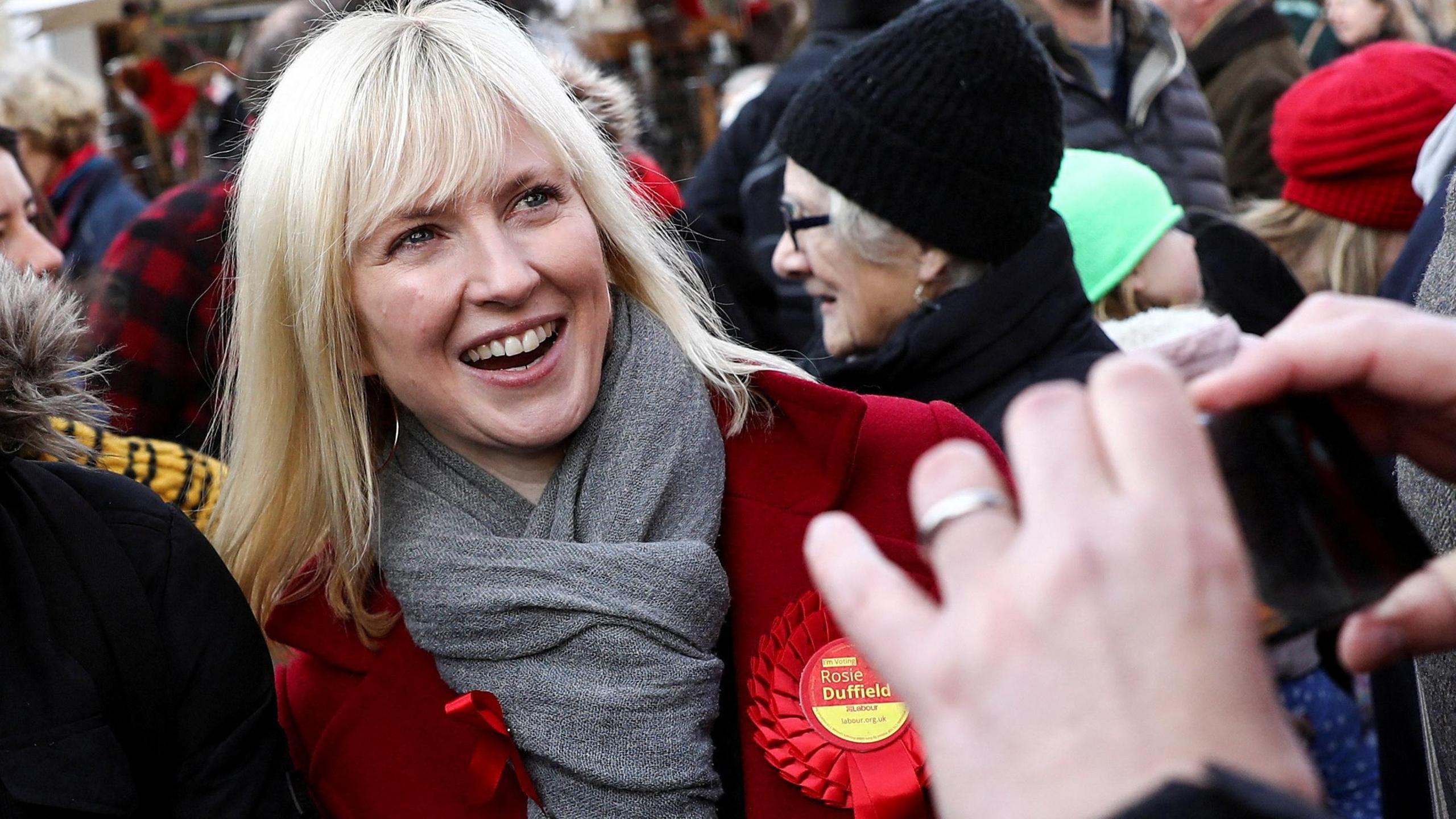 Rosie Duffield attends a Labour rally wearing a red rosette in 2019